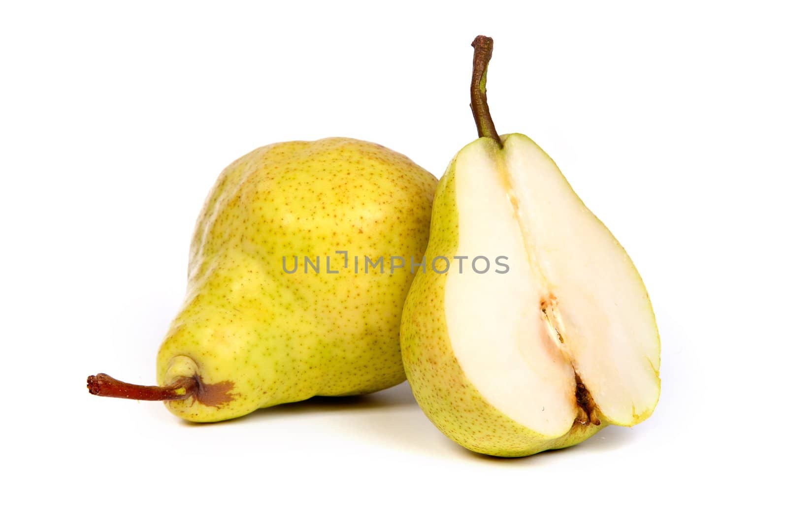 Whole peat and pear cuts in half isolated on a white background