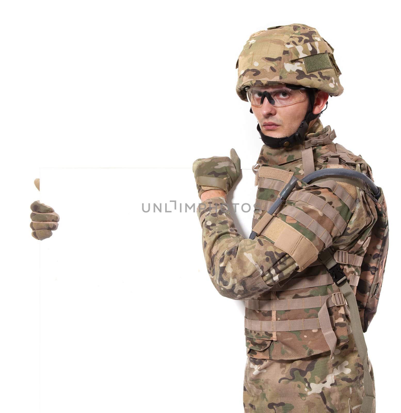 Modern soldier holding a poster isolarted on white