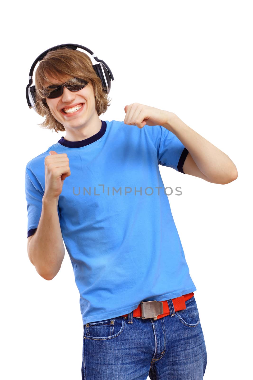 Happy smiling young man dancing and listening to music