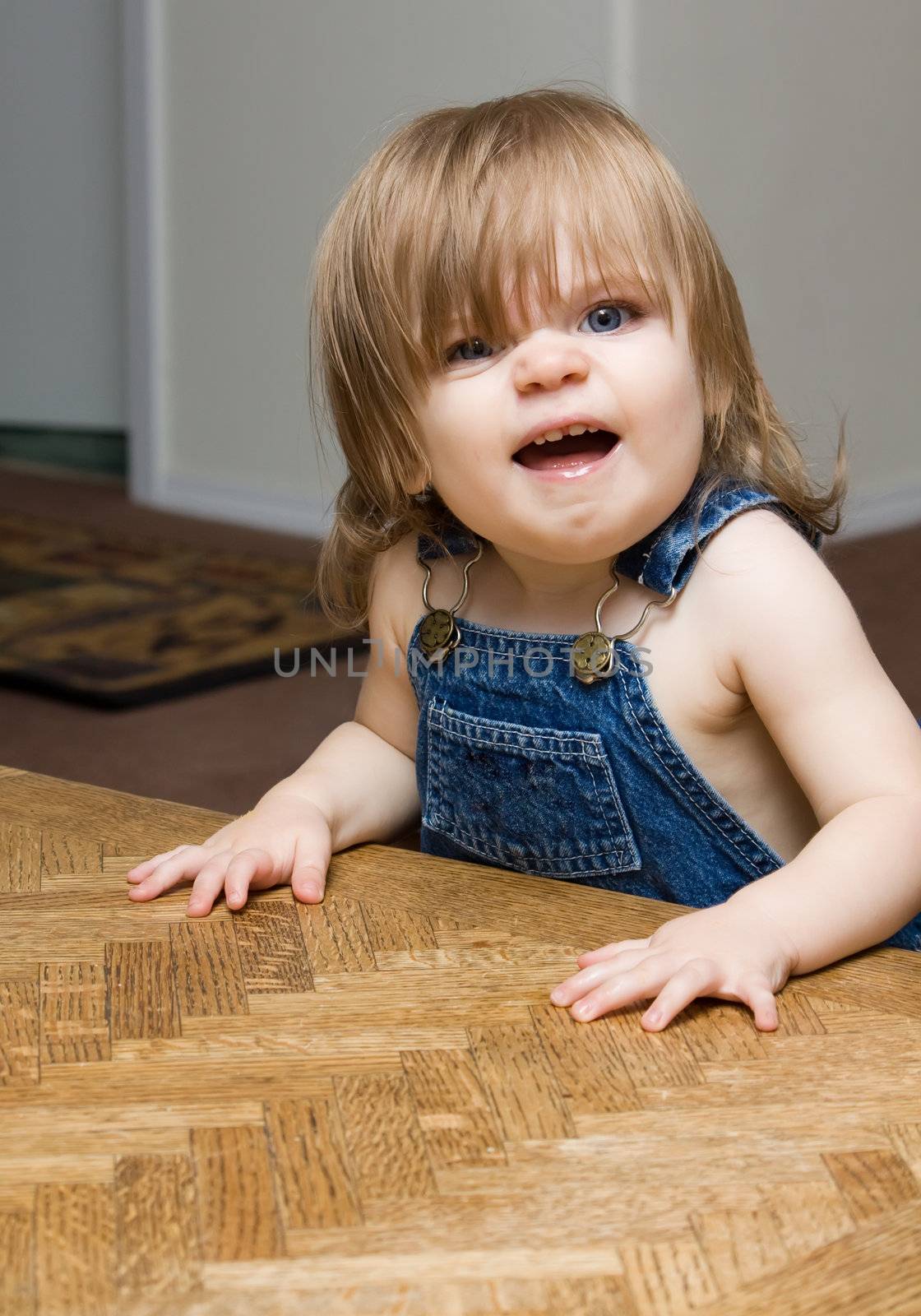 Smiling child in overalls