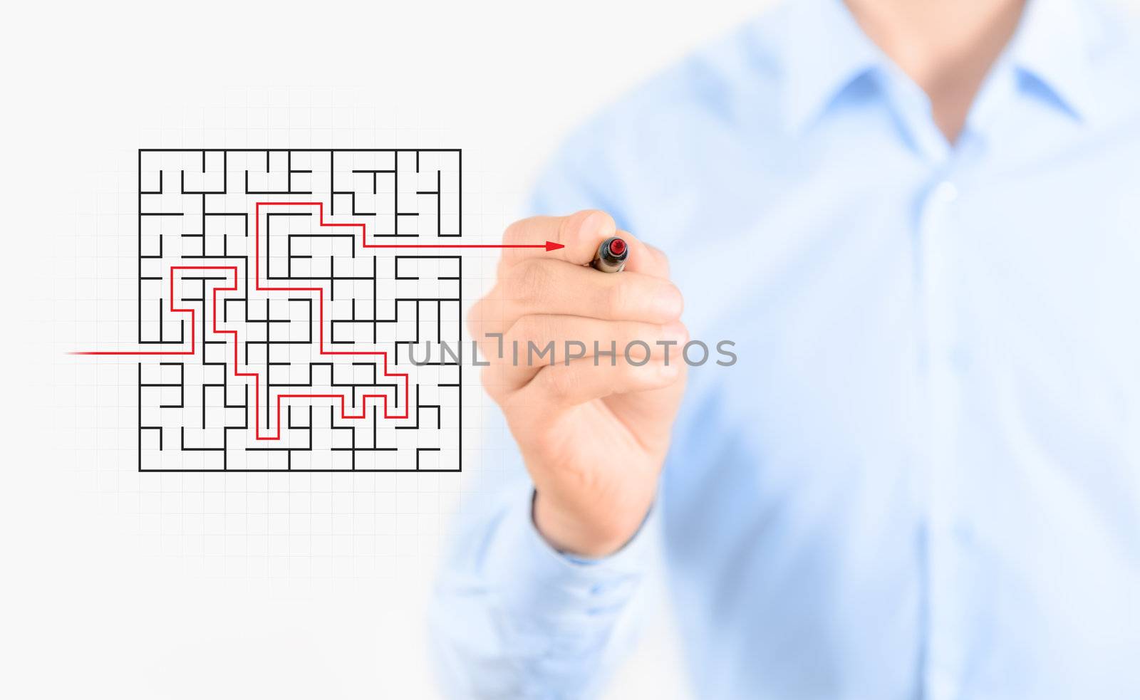 Young businessman drawing success way to find solution concept. Isolated on white.