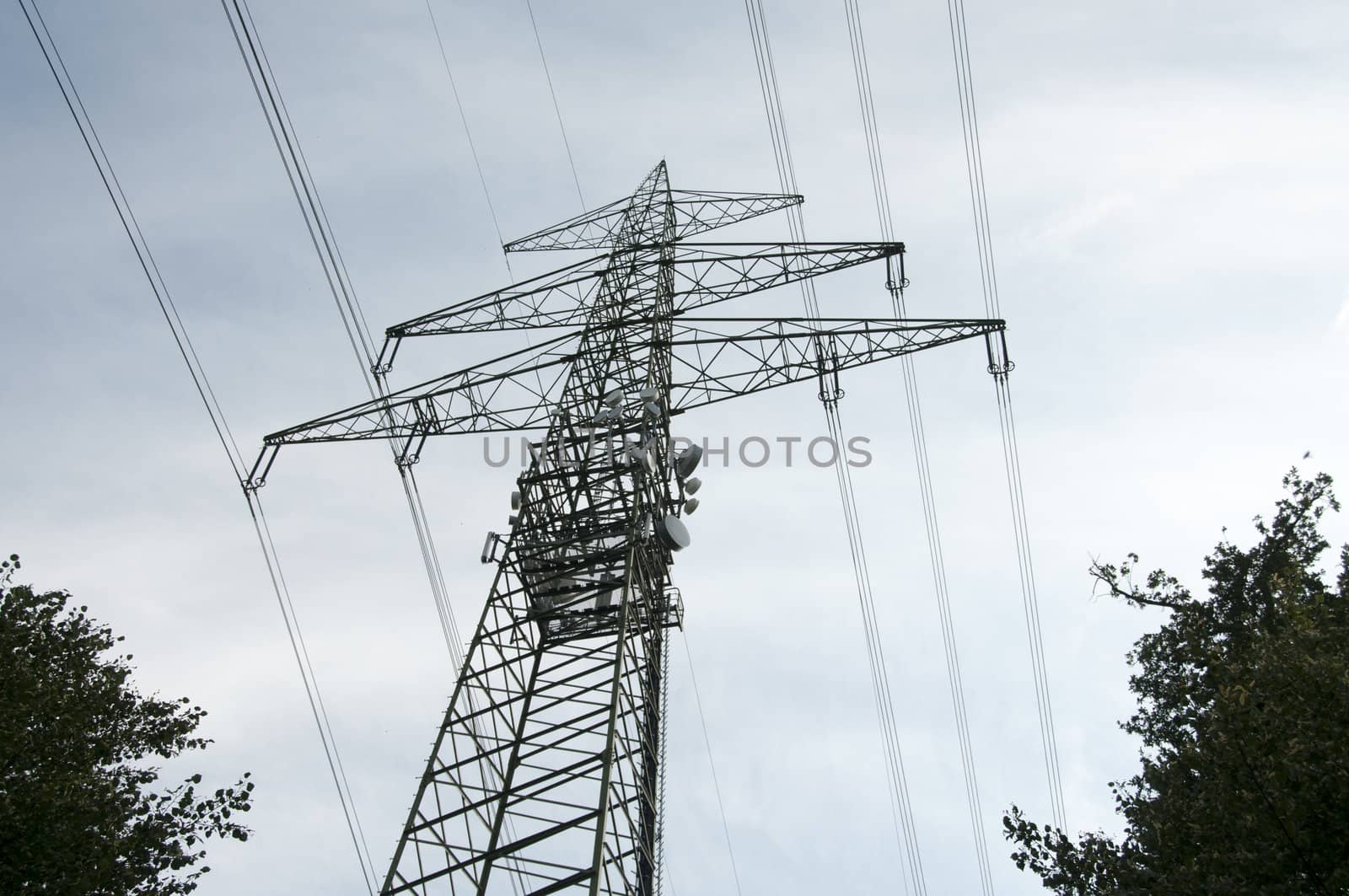 high voltage power electricity pylons under sky