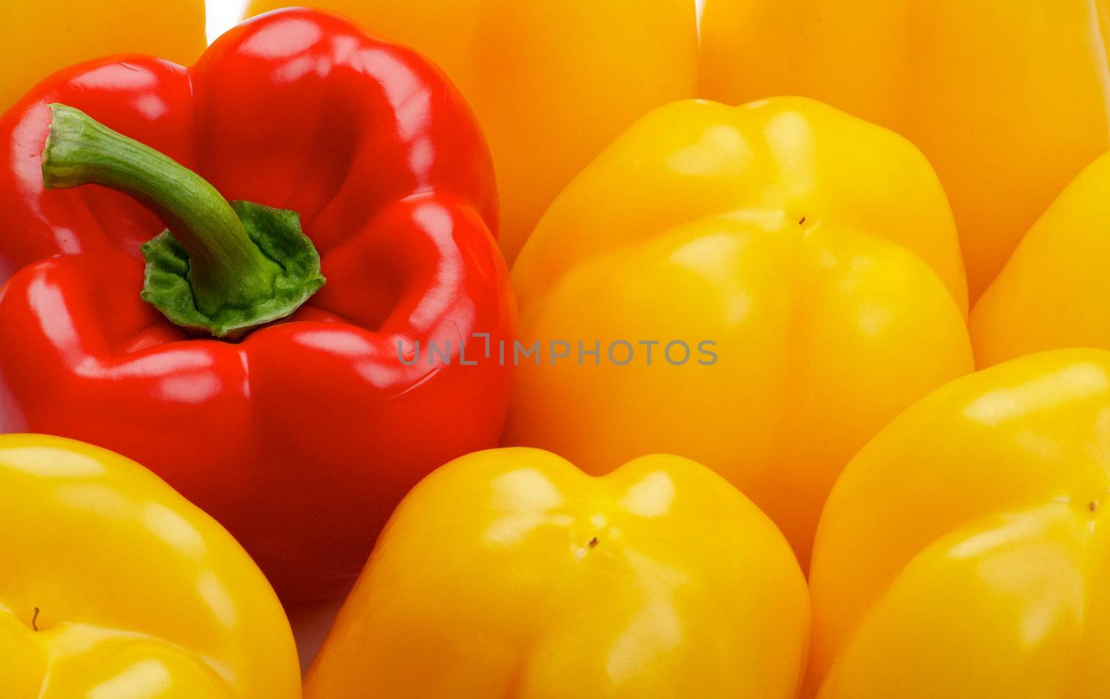 Background of One Red and Some Yellow Bell Peppers close up  top view 