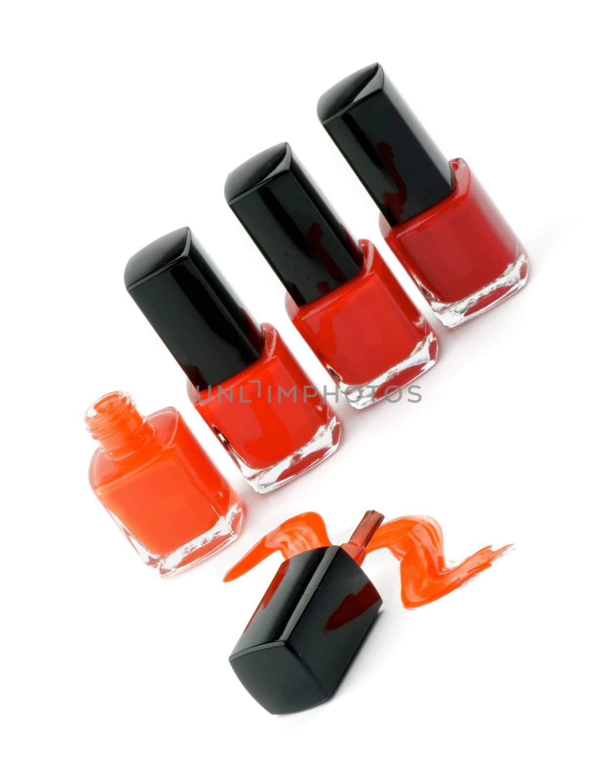 Four Bright Nail Varnishs and Spilled with Brush isolated on white background