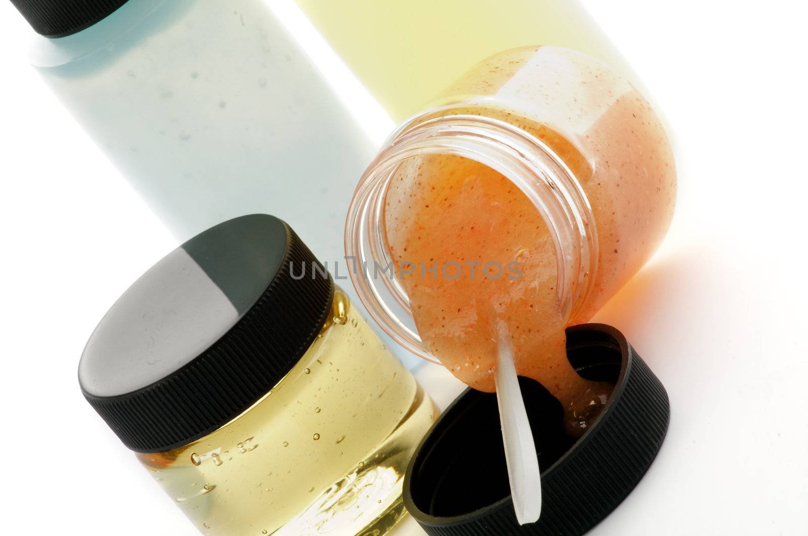 Arrangement of Facial Cosmetics with Apricot Scrub, Facial Cleanser, Facial Foam and Mousturizer in Containers isolated on white background