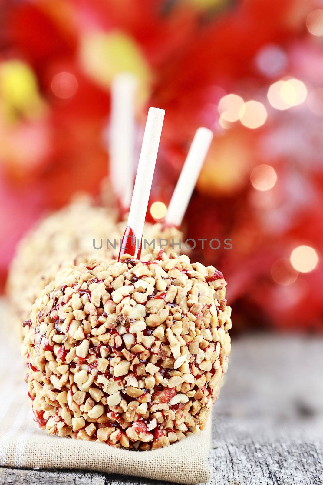 Three candy covered apples on napkin. Extreme shallow depth of field with selective focus on first apple.
