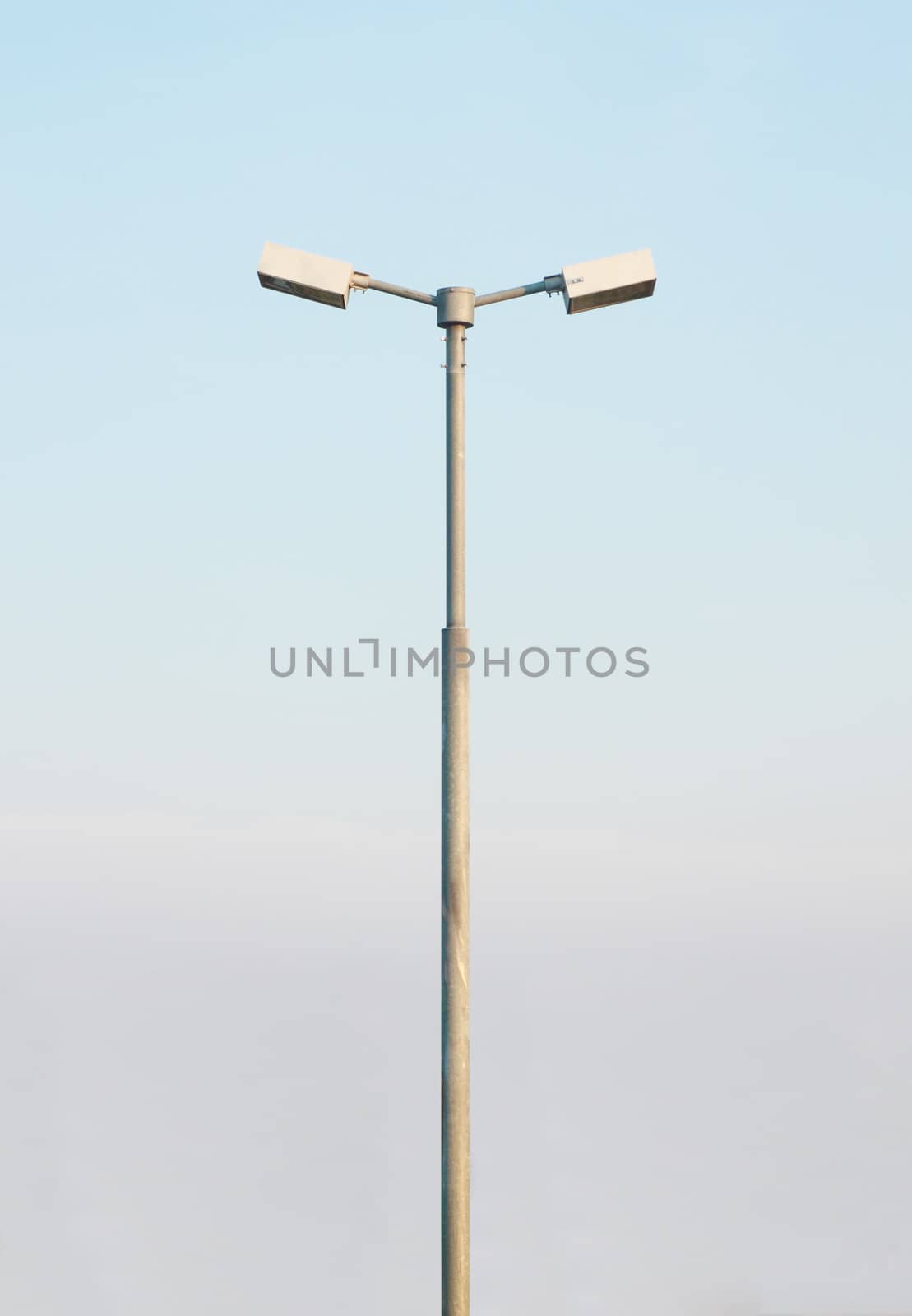 double street light lamp post with blue sky background