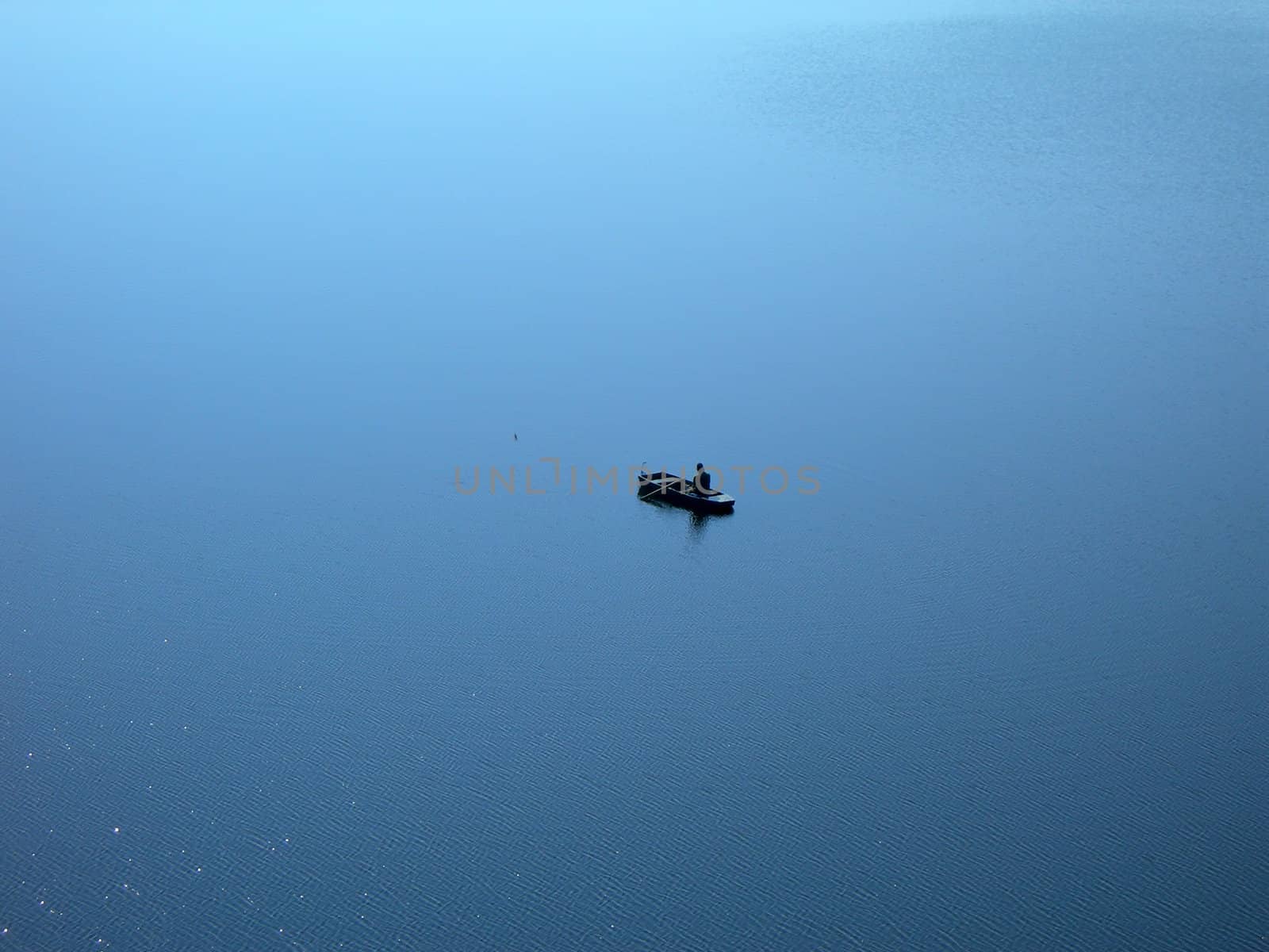  Lonely fishermen surrounded by endless water