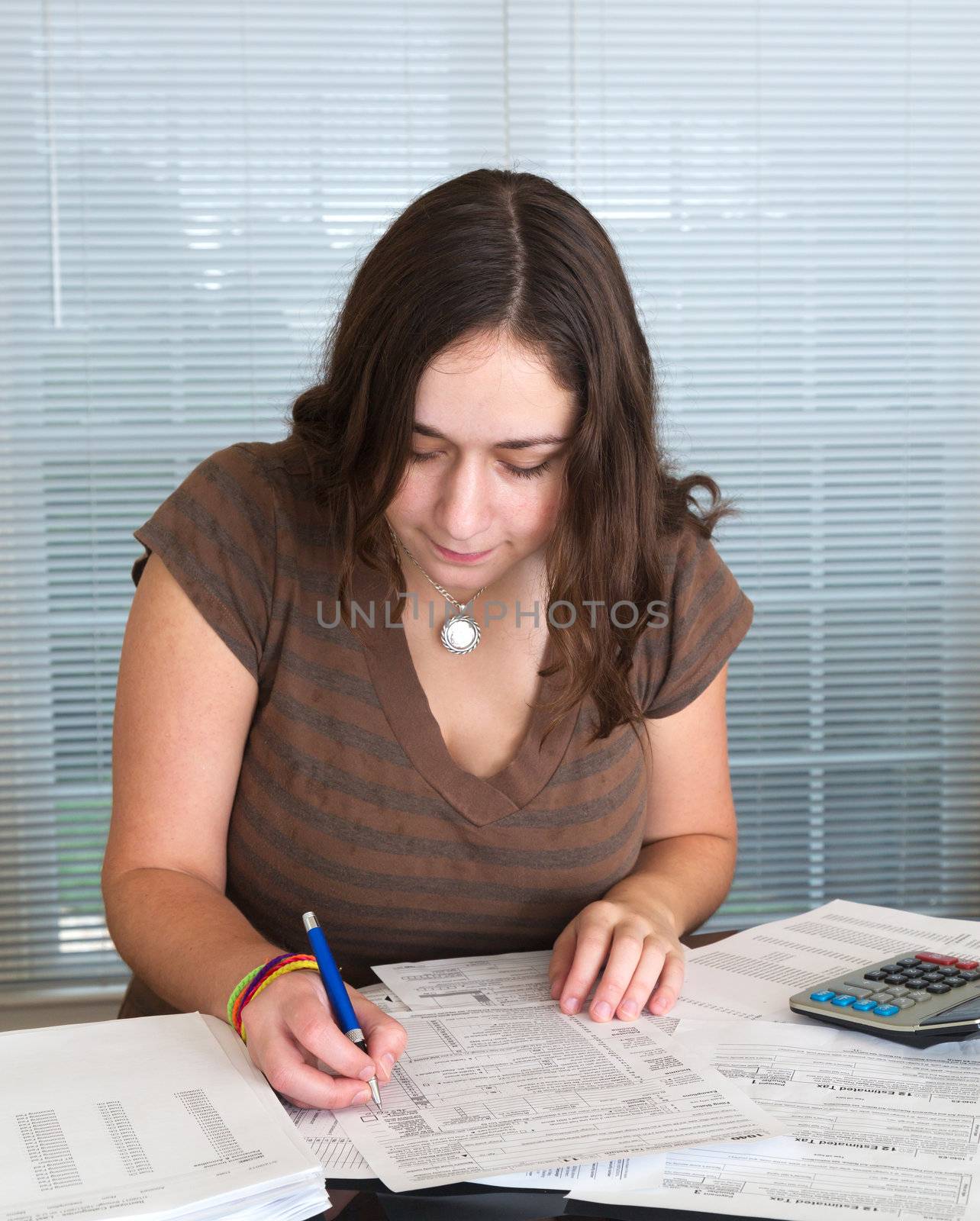 Young lady preparing USA tax form 1040 for 2012 by steheap