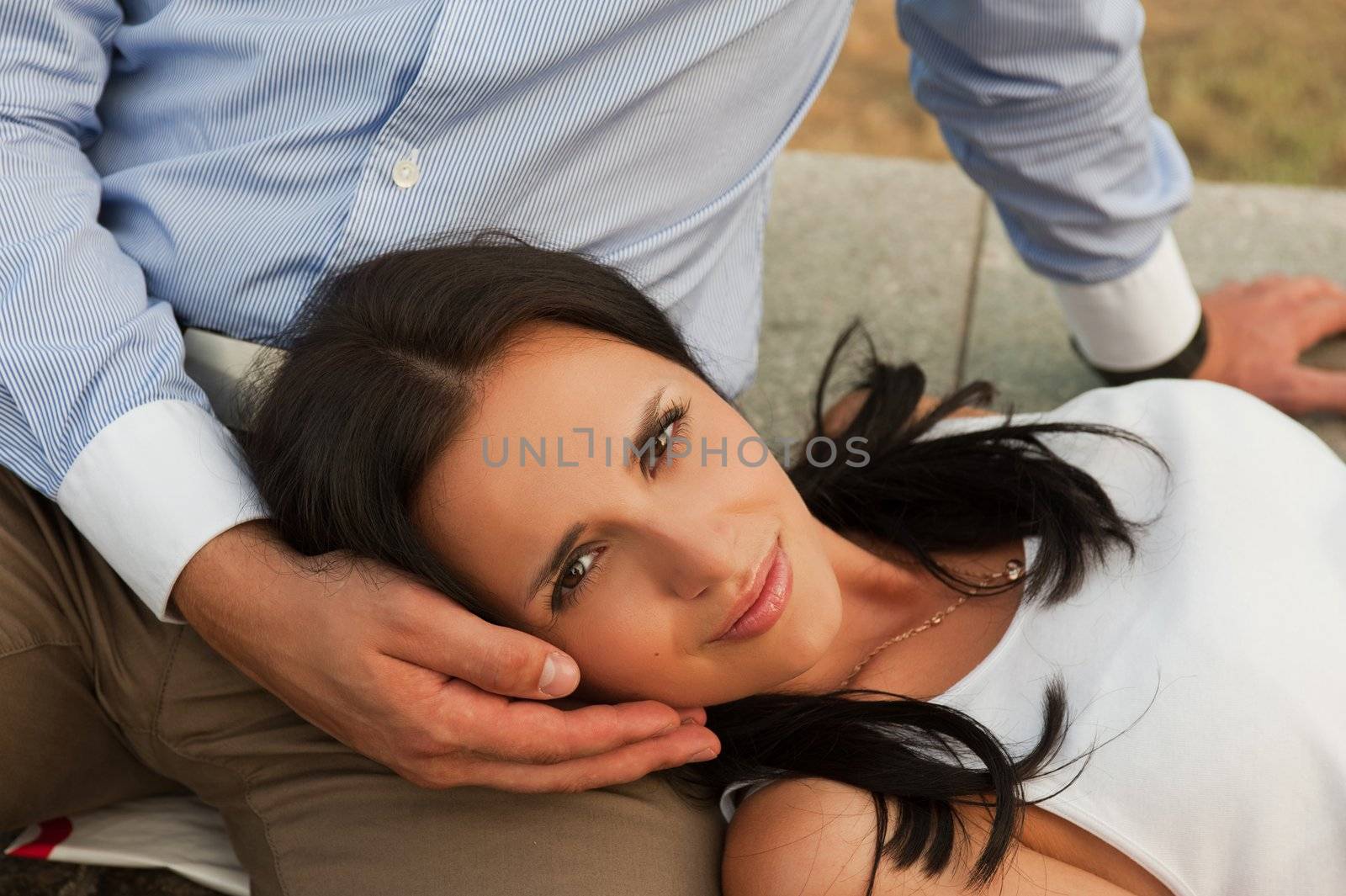 woman lying at mans knees at outdoor