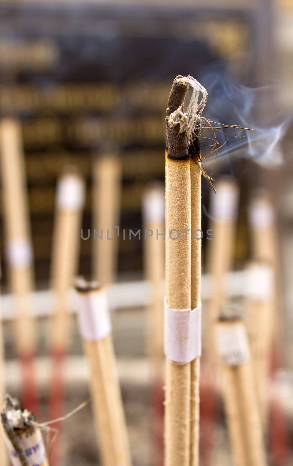Burning incense sticks at a buddhist temple in thailand