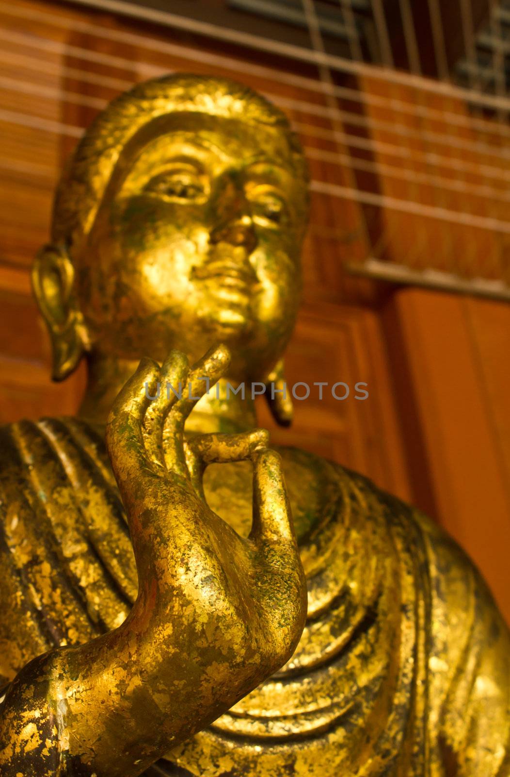 Golden buddha statue close-up and depth-of-field