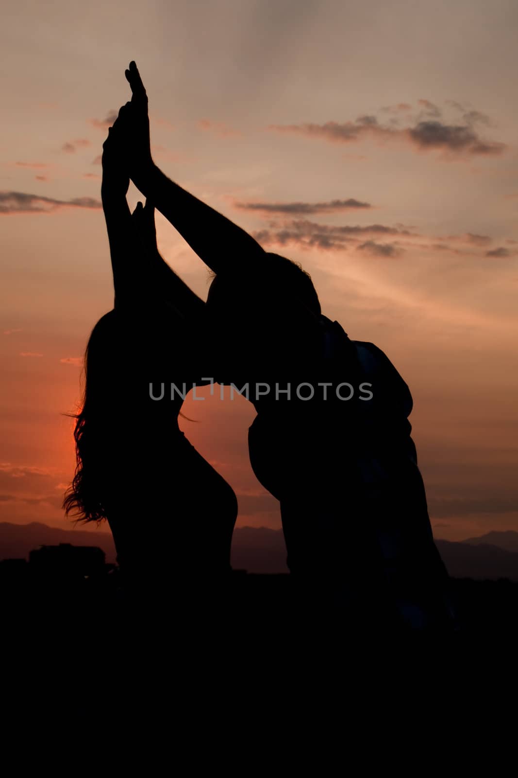 Couple kissing at sunset silhouette