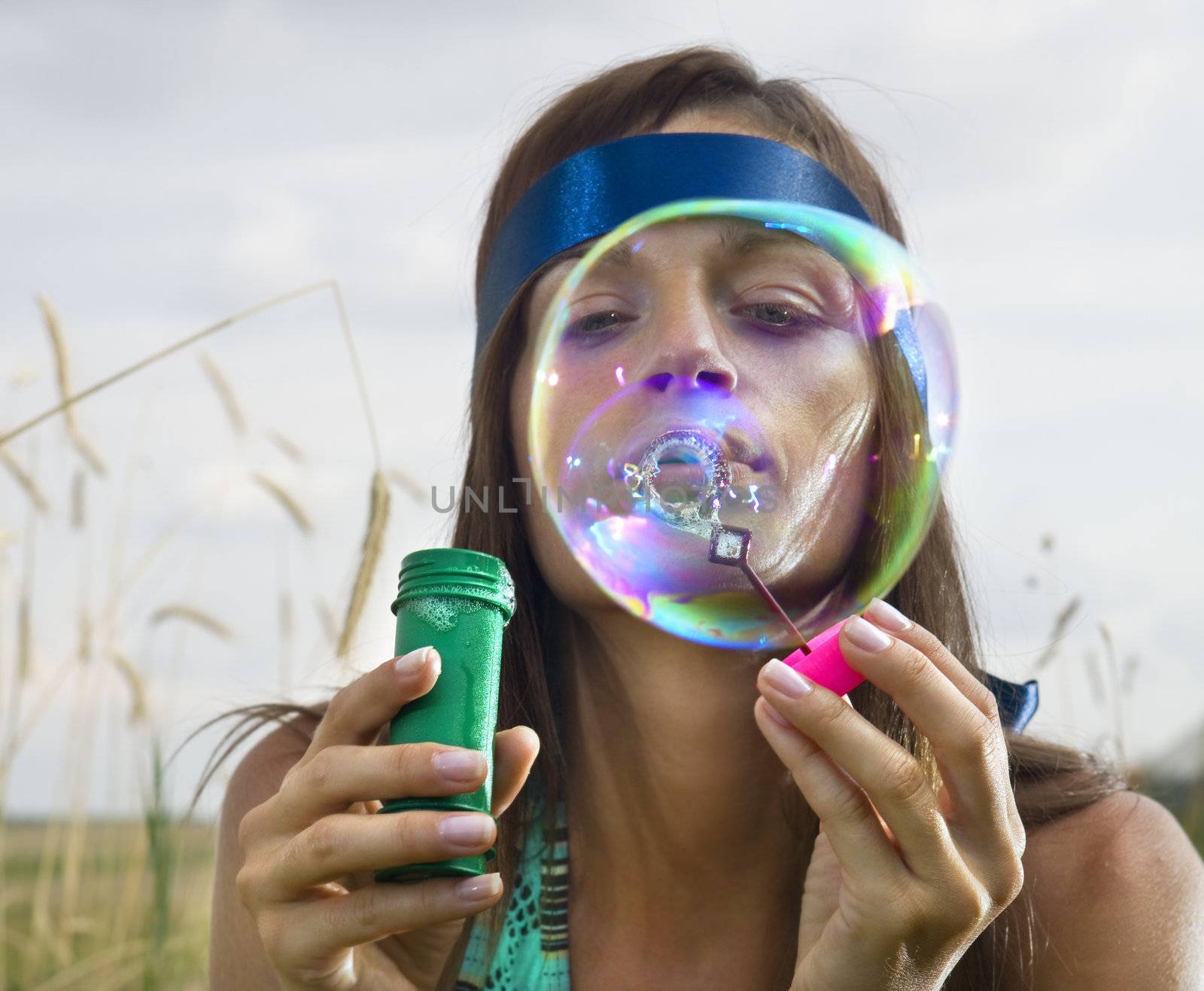 face of woman that blows soap bubbles by ssuaphoto