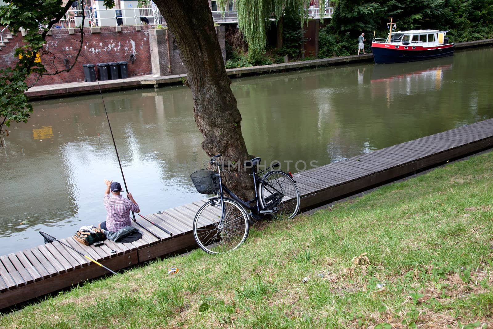 man fishing in canal in Utrecht in The Netherlands