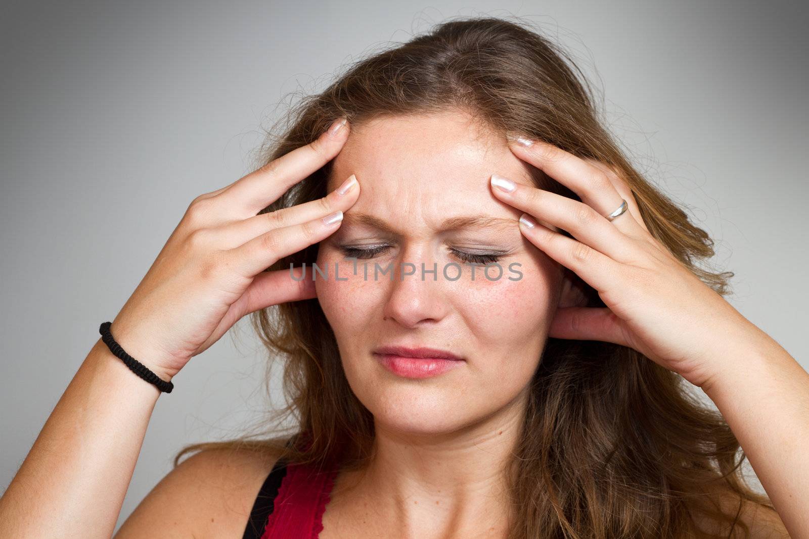 young blond woman having a headache close up 