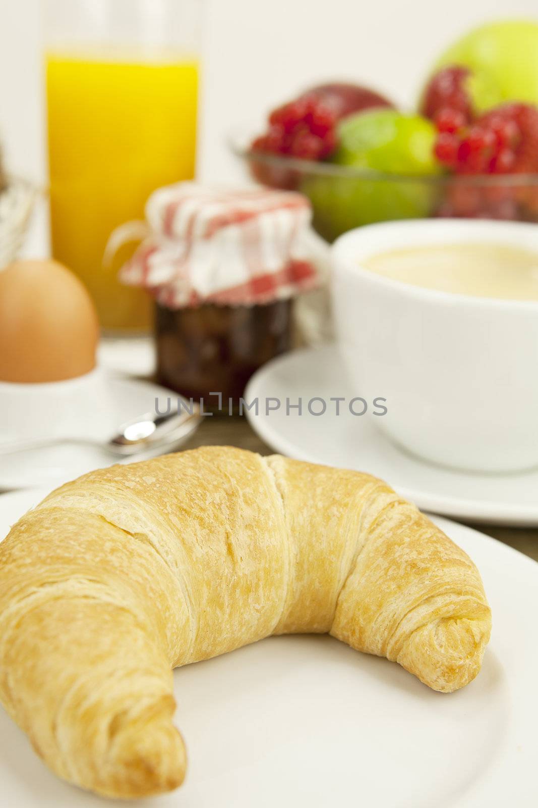 traditional french breakfast in morning on wooden background