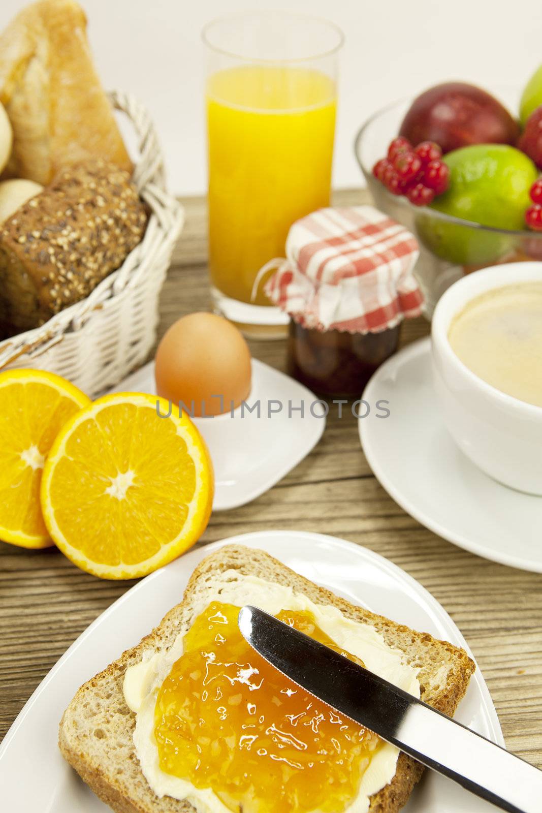 tasty breackfast with toast and marmelade on wooden background