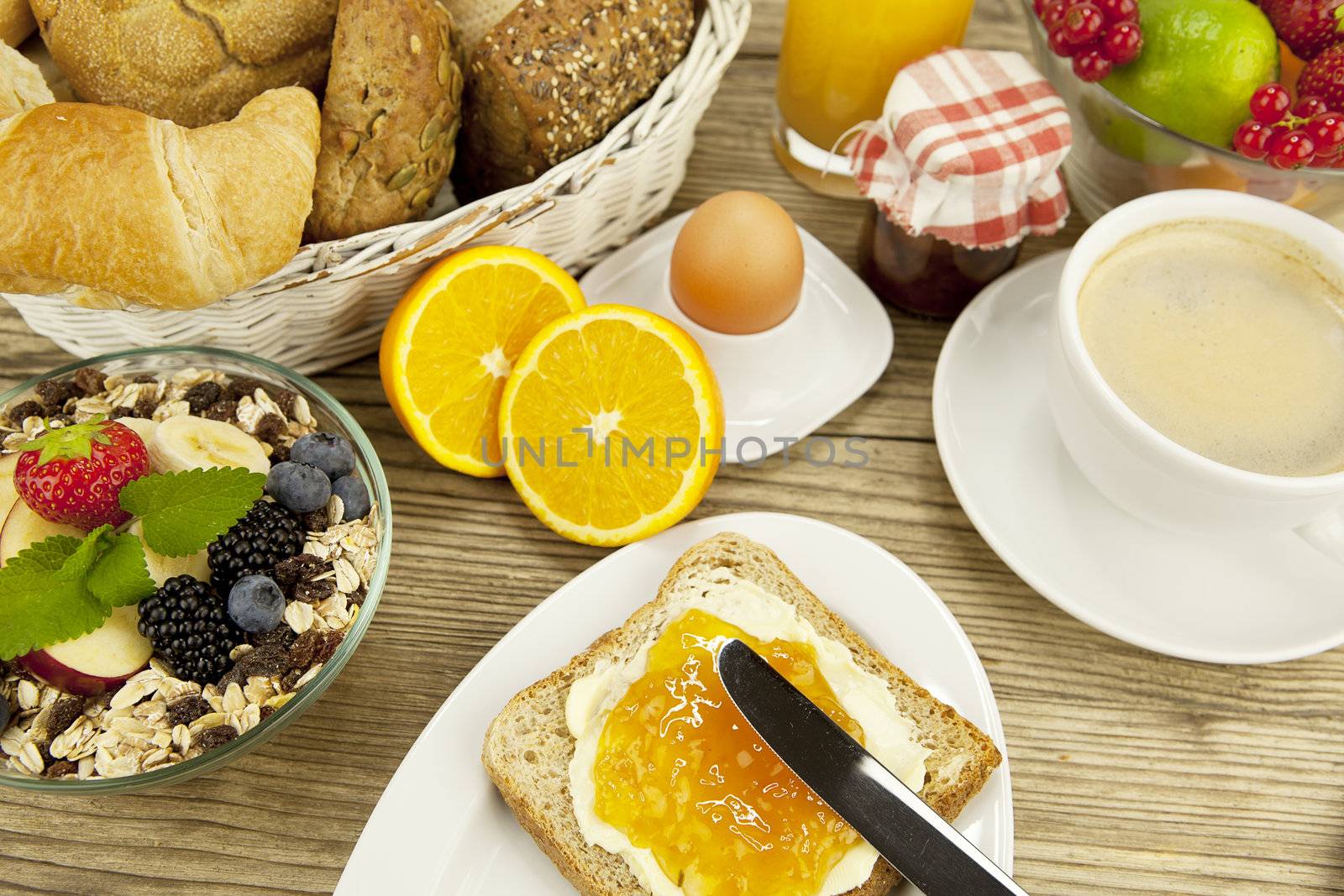 tasty breackfast with toast and marmelade on wooden background