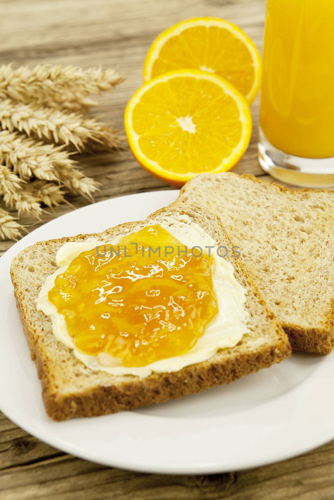 tasty breackfast with toast and marmelade on wooden background