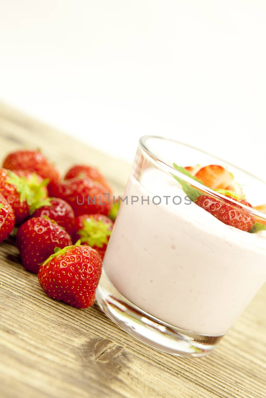 fresh tasty strawberry yoghurt shake dessert on wooden background