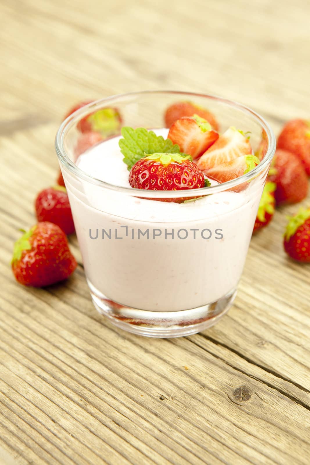 fresh tasty strawberry yoghurt shake dessert on wooden background