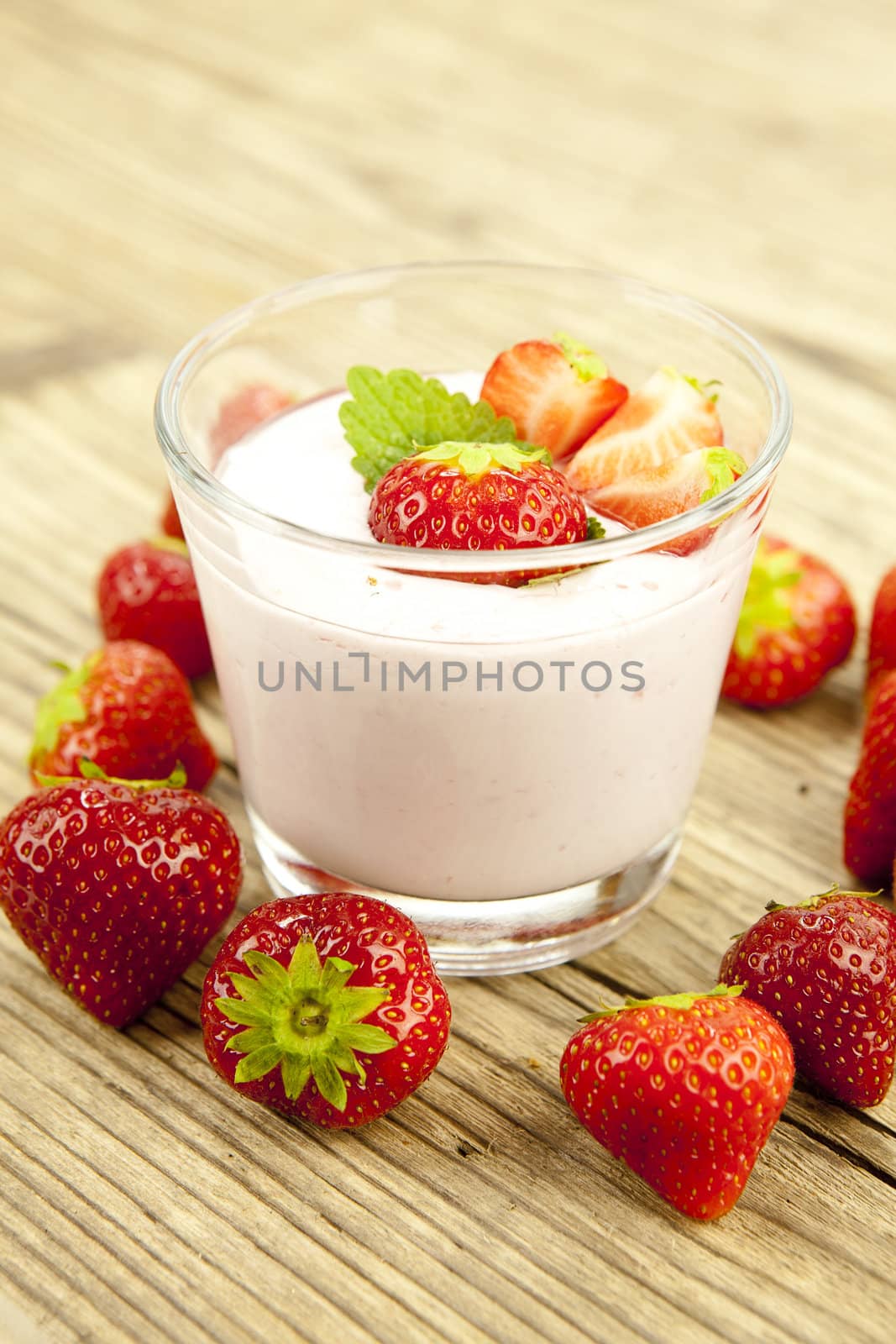 fresh tasty strawberry yoghurt shake dessert on wooden background