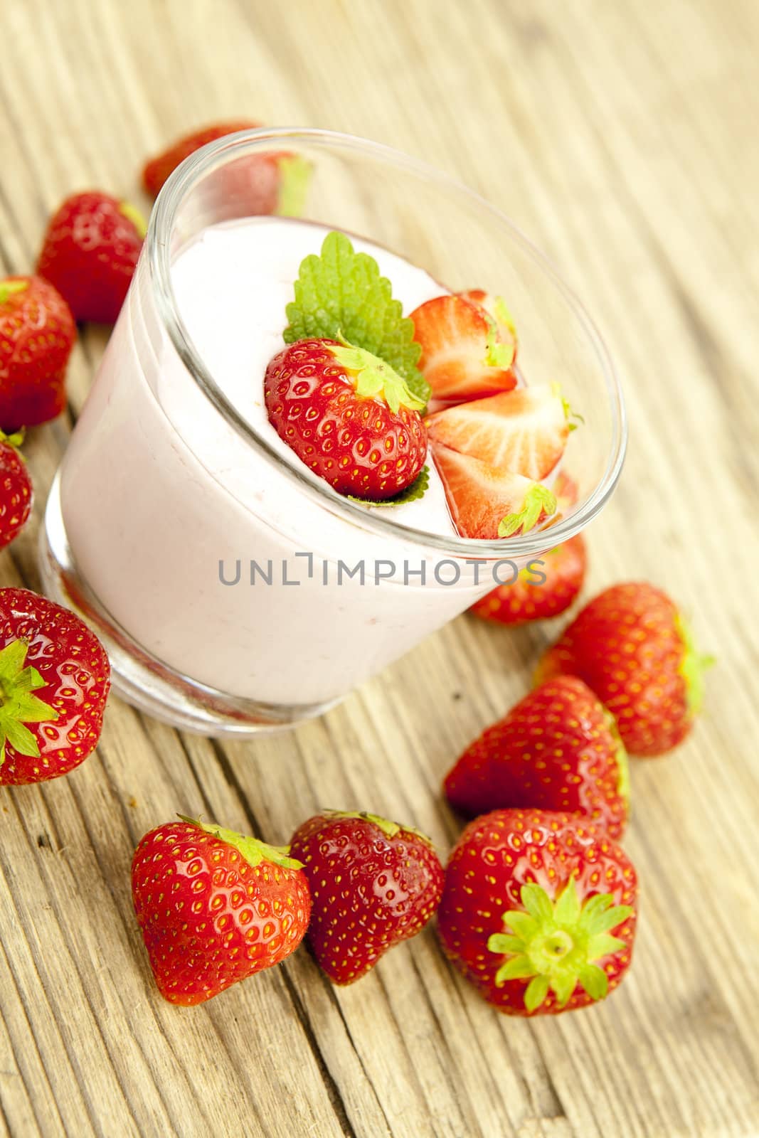 fresh tasty strawberry yoghurt shake dessert on wooden background