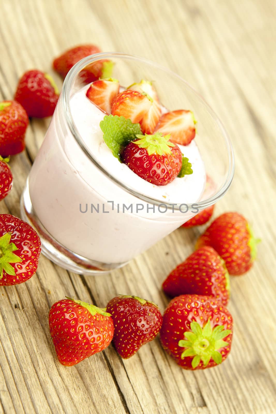 fresh tasty strawberry yoghurt shake dessert on wooden background