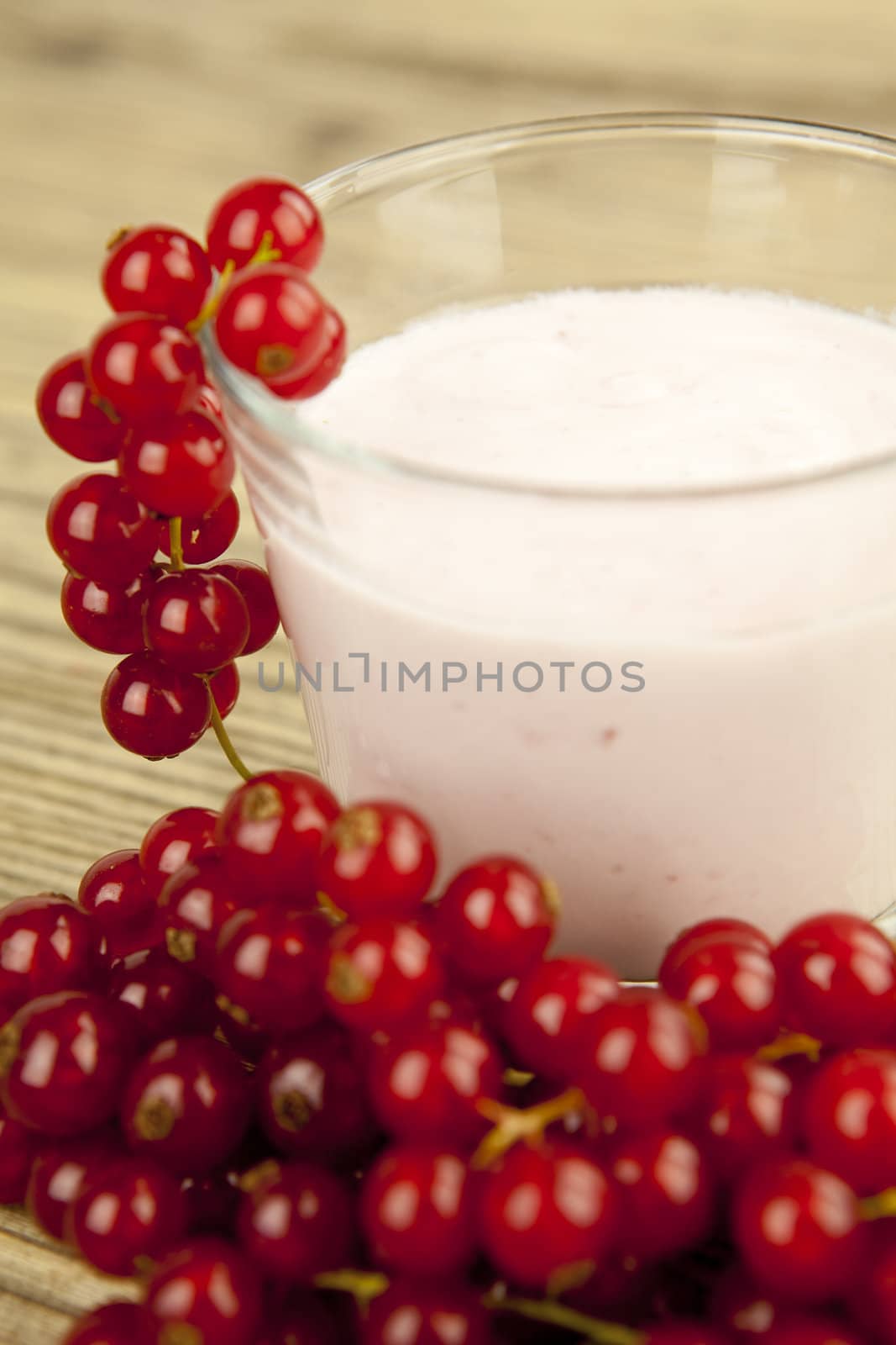 deliscious fresh currant yoghurt shake dessert on wooden background