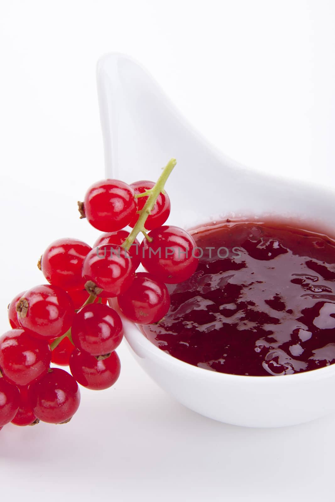 tasty fresh red currant jam isolated on white background