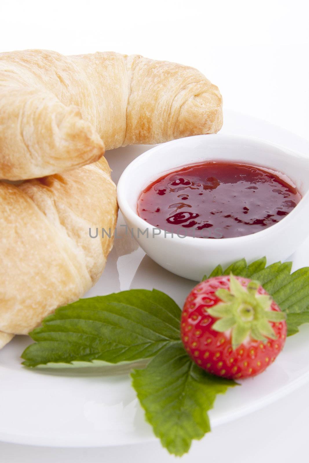 deliscios fresh croissant with strawberry jam isolated on white background