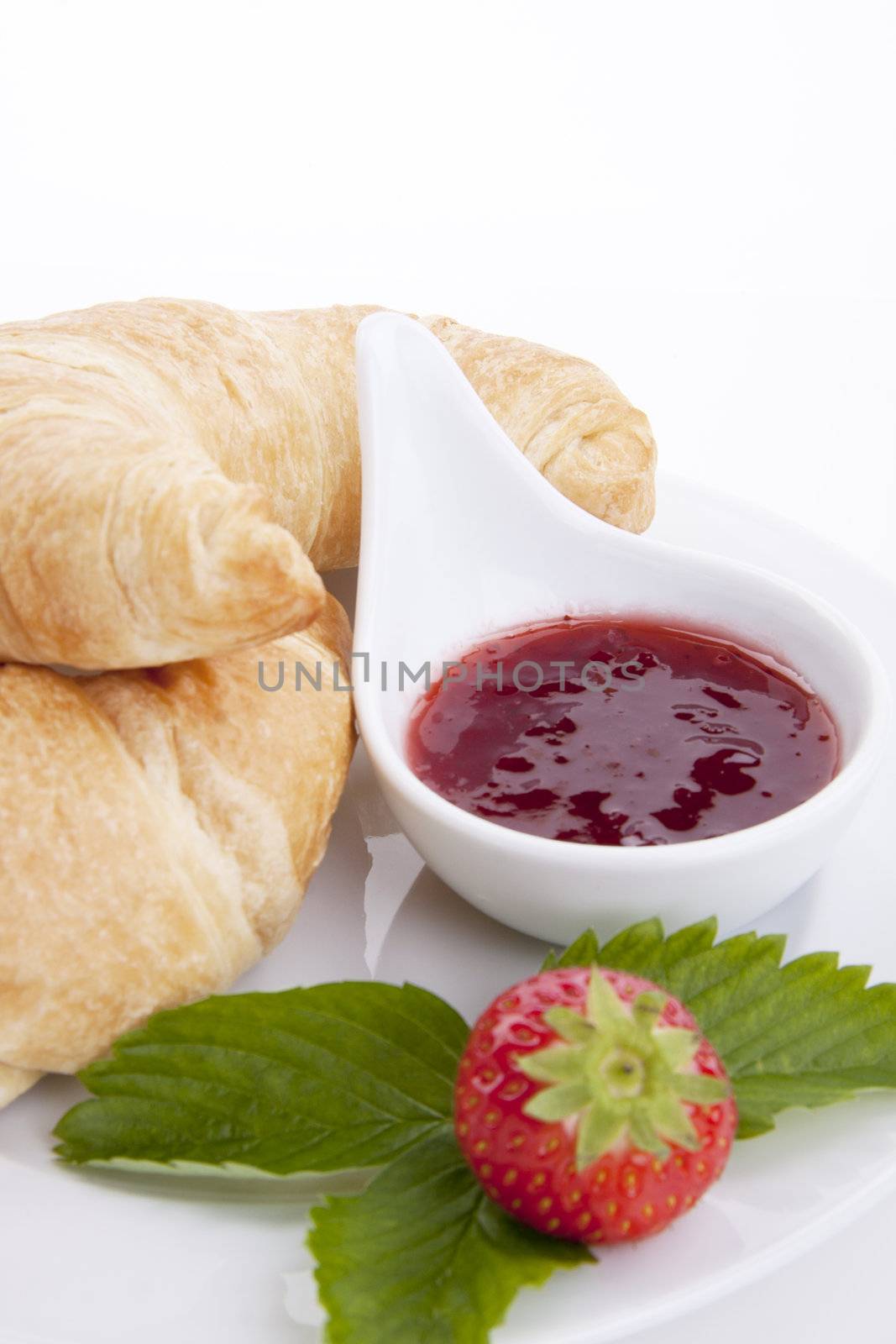 deliscios fresh croissant with strawberry jam isolated on white background