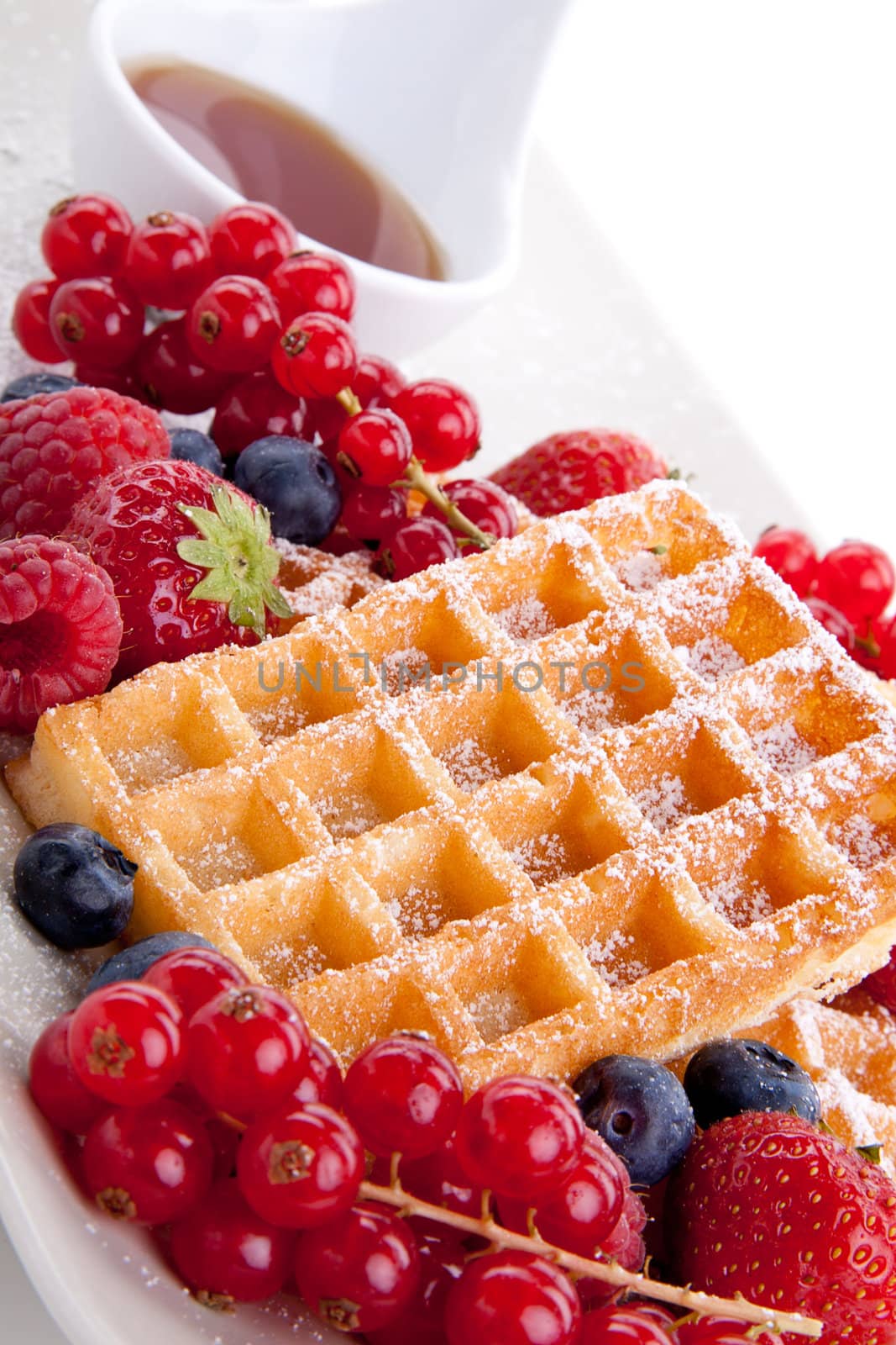 sweet fresh tasty waffles with mixed fruits isolated on white background