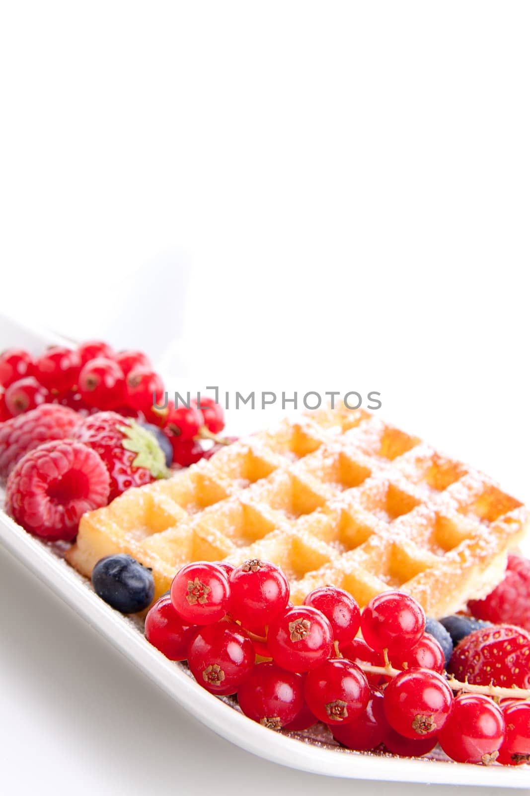 sweet fresh tasty waffles with mixed fruits isolated on white background