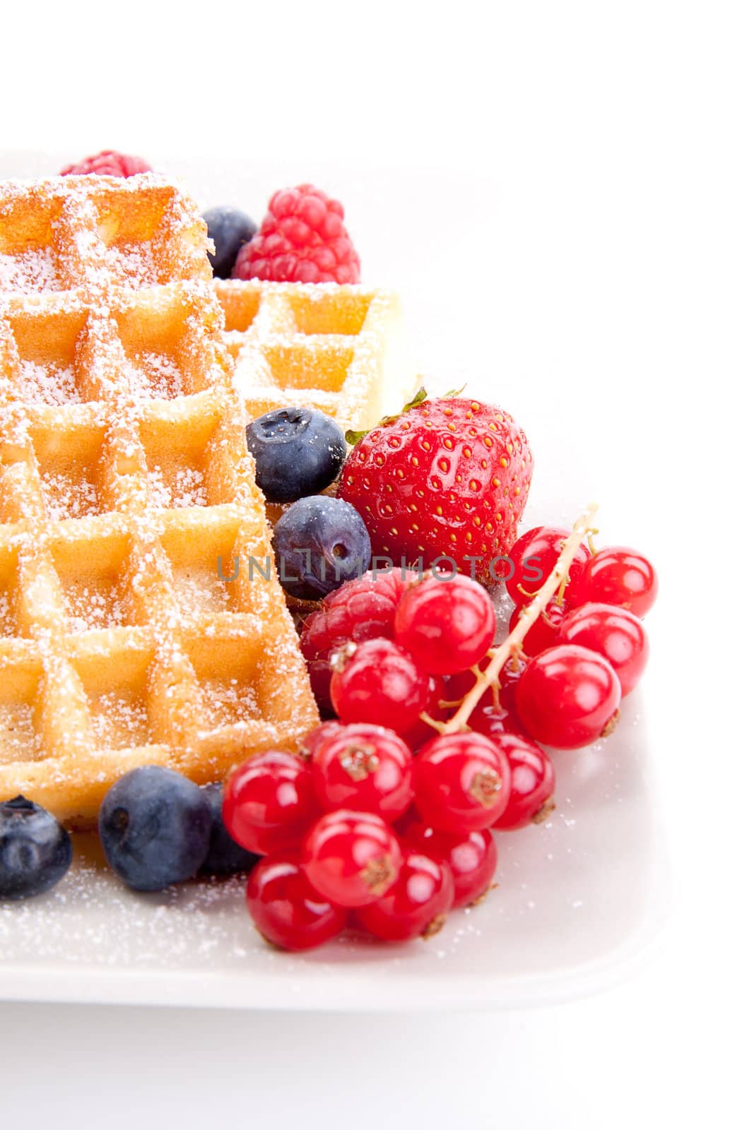 sweet fresh tasty waffles with mixed fruits isolated on white background