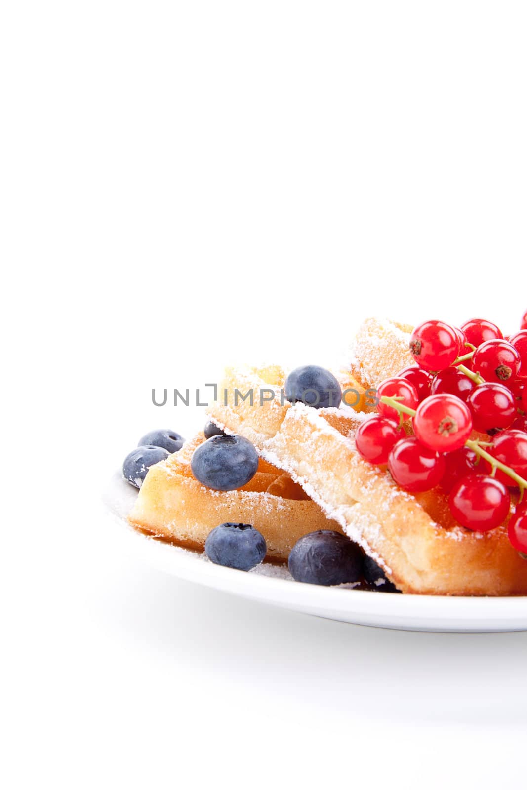 sweet fresh tasty waffles with mixed fruits isolated on white background