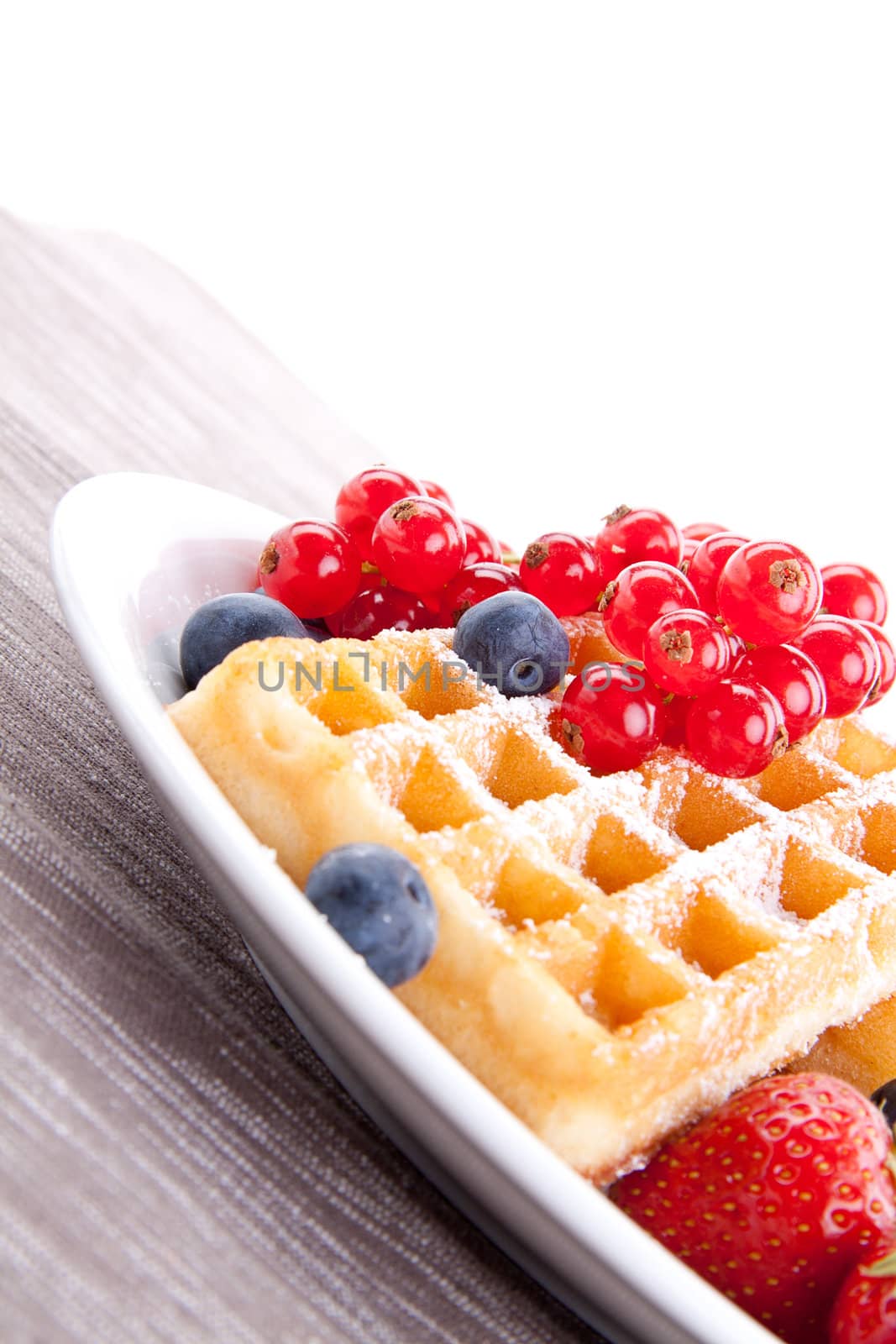 sweet fresh tasty waffles with mixed fruits isolated on white background