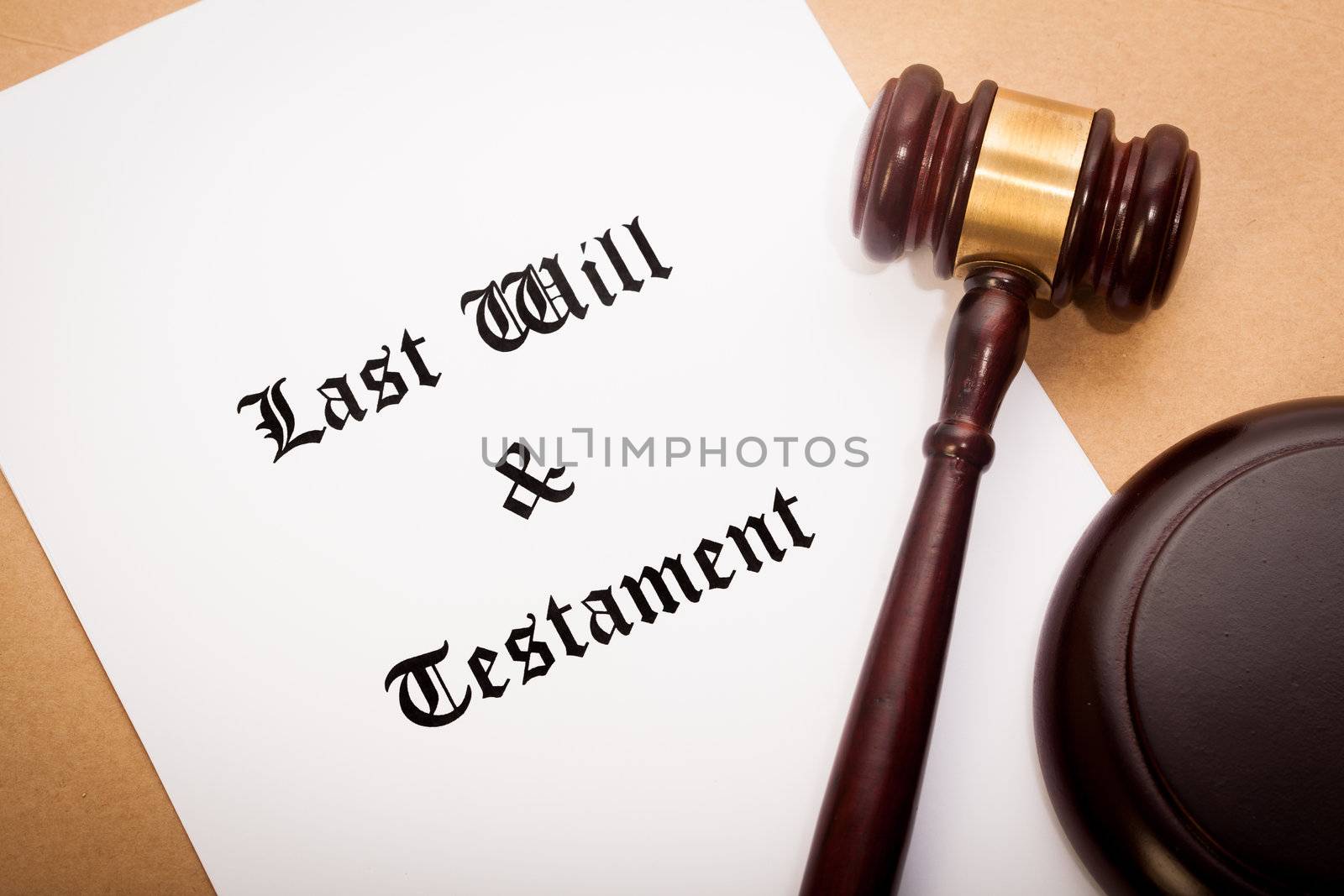 A gavel and soundboard on top of a "Last Will and Testament" contract, with a antique-like background.