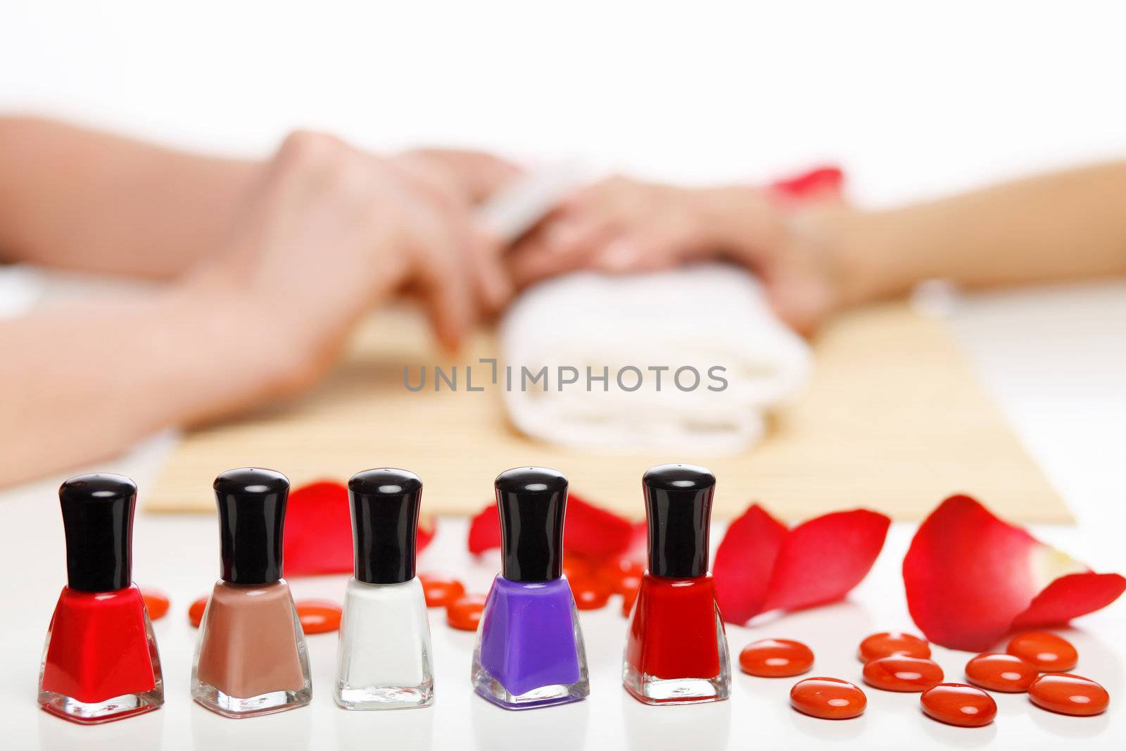 Young woman is getting manicure in a beauty salon