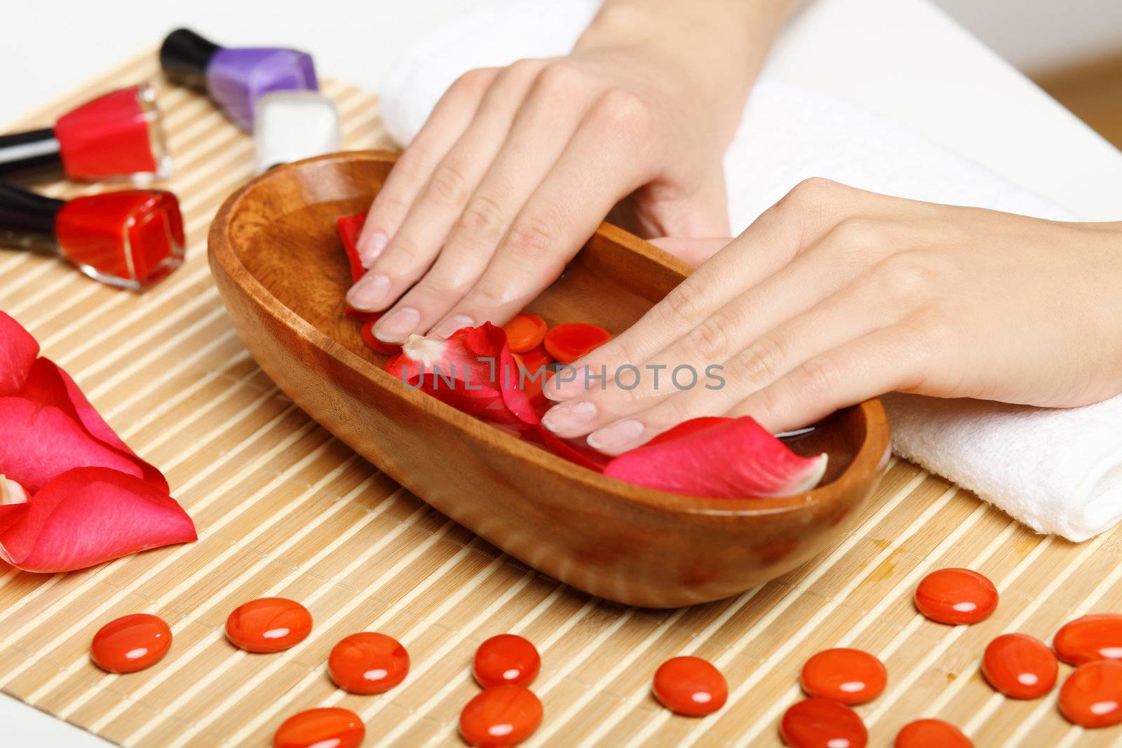 Young woman is getting manicure in a beauty salon