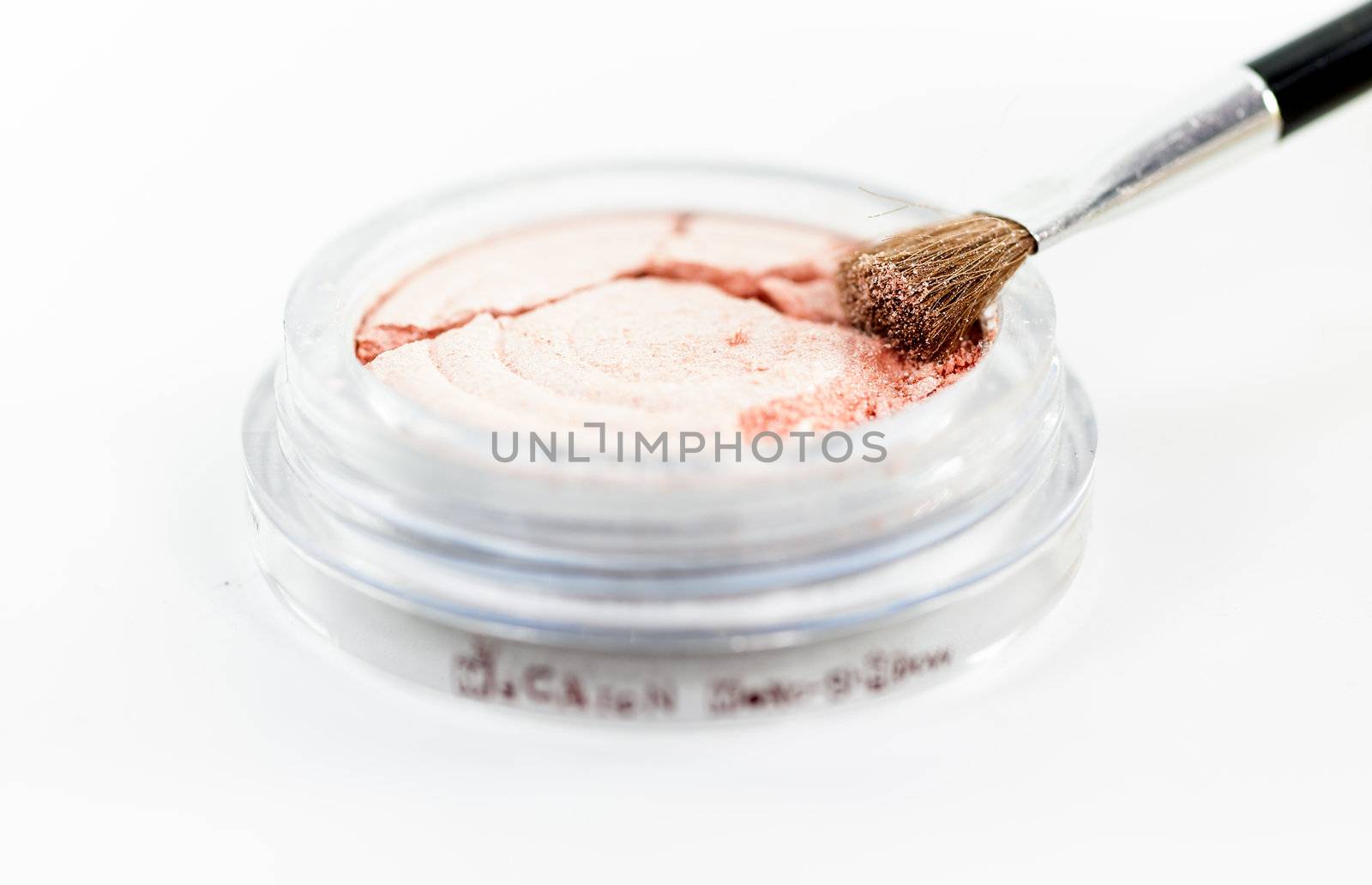 Makeup powder in sphere box with brush on white background isolate