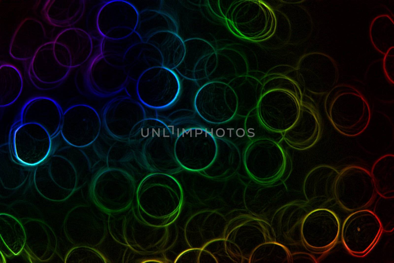 Abstract Neon rainbow colored rings on a black background