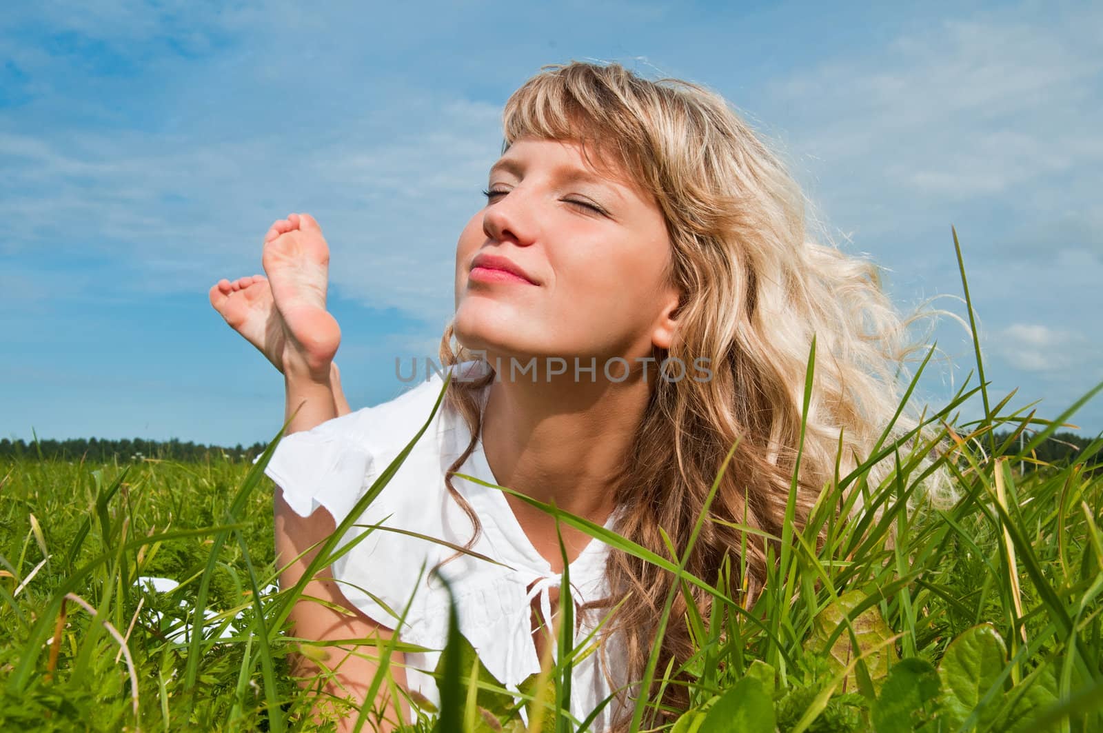 Girl lying on grass and smiling