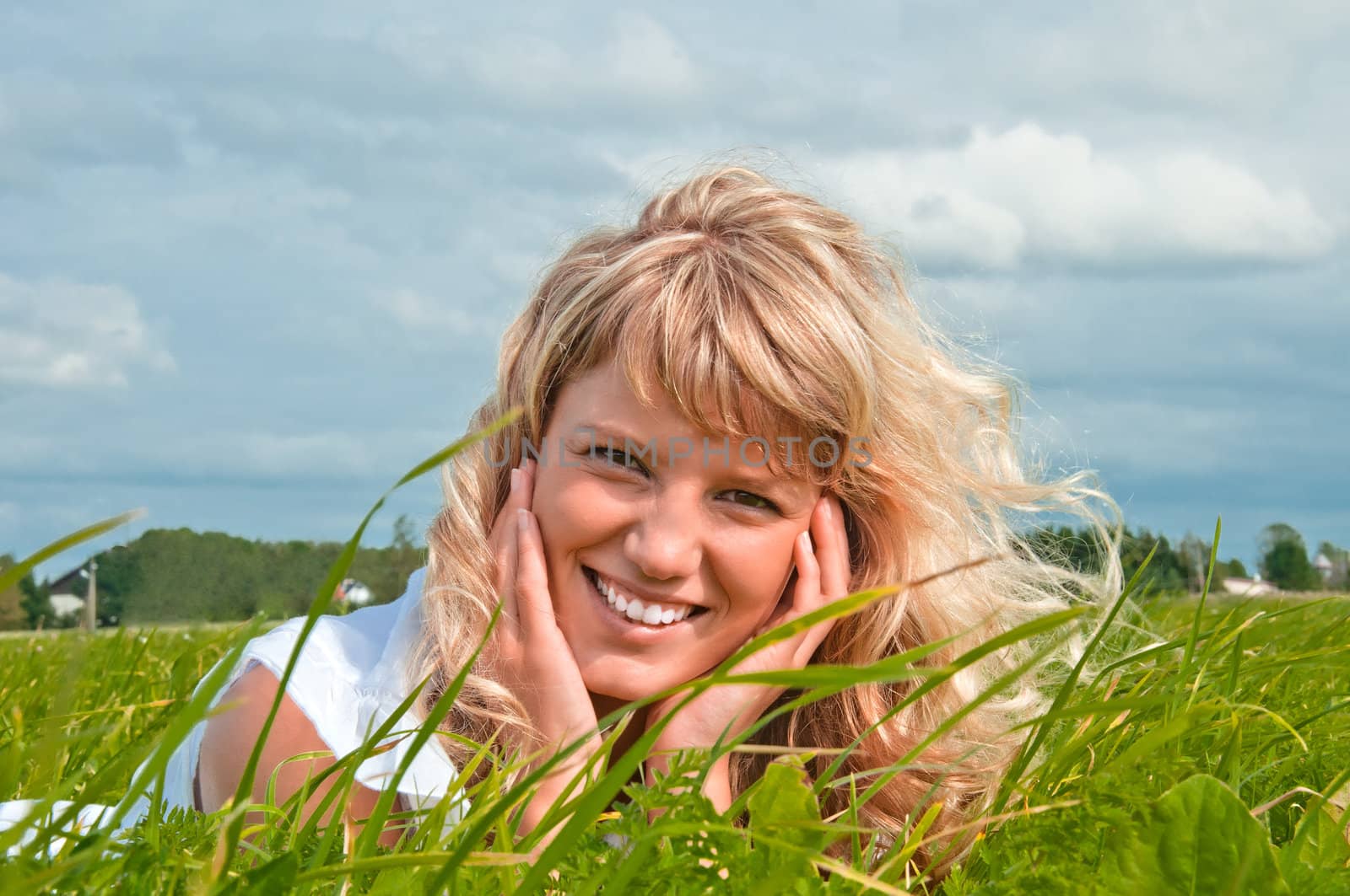 Girl lying on grass and smiling