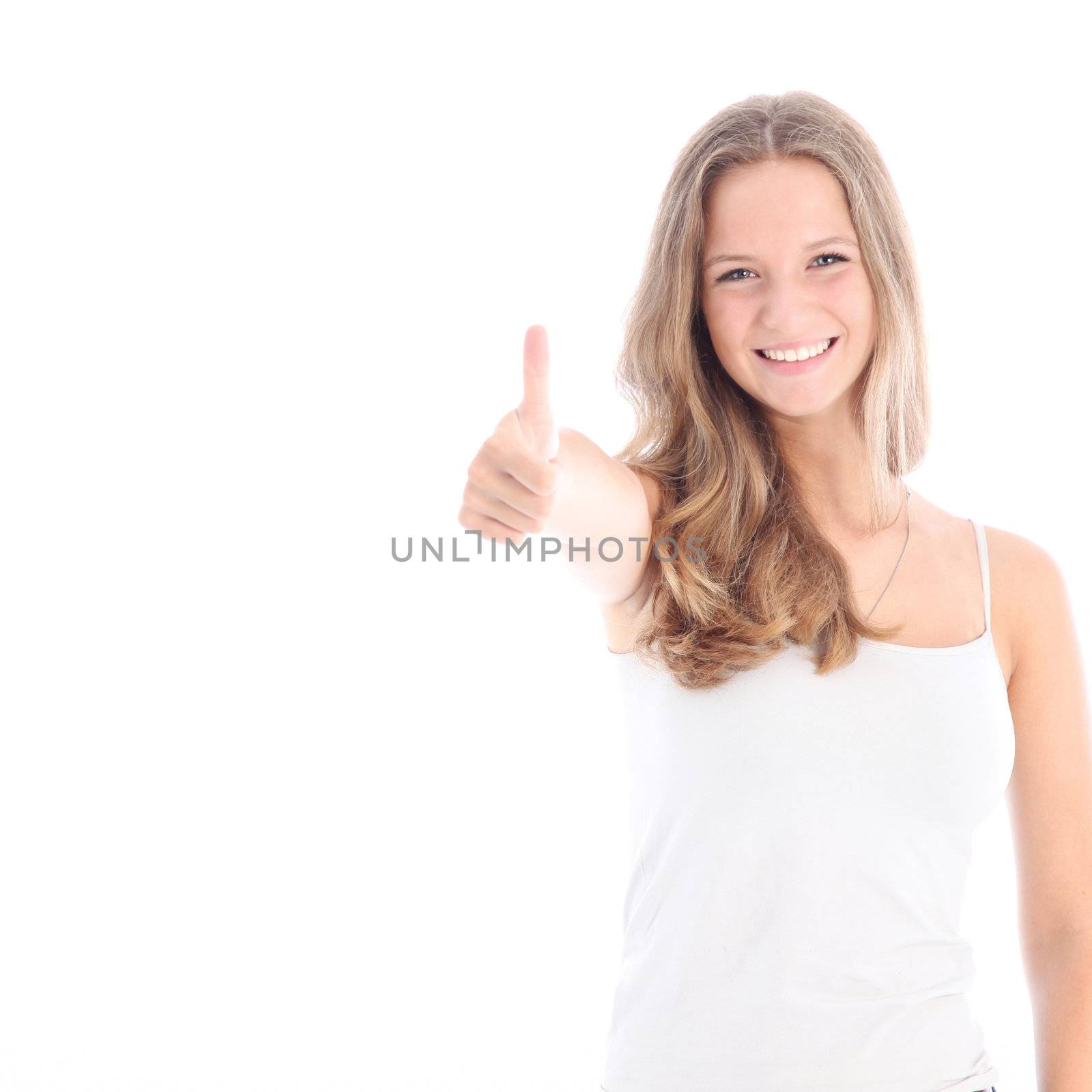 Happy smiling young teenager with a positive outlook giving a thumbs up of approval isolated on white 