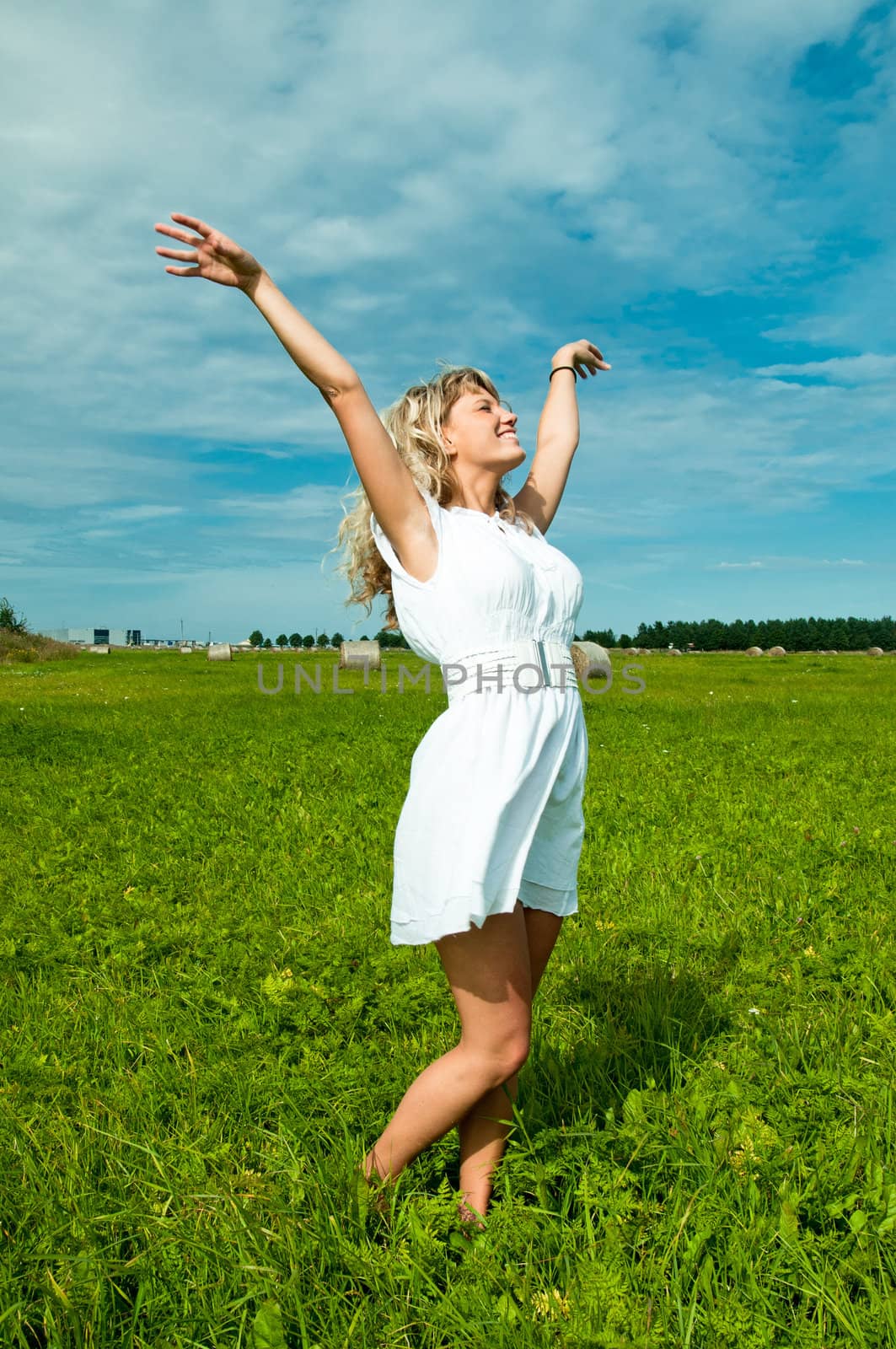 Girl Standing on grass and smiling