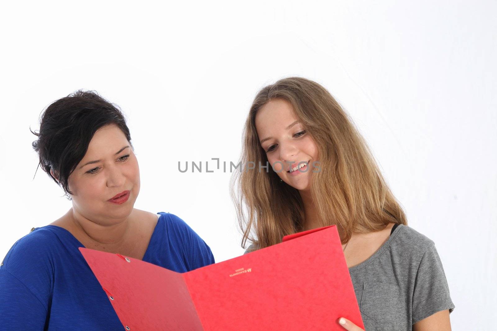 Proud young teenage daughter showing her mother her work in a red folder isolated on white