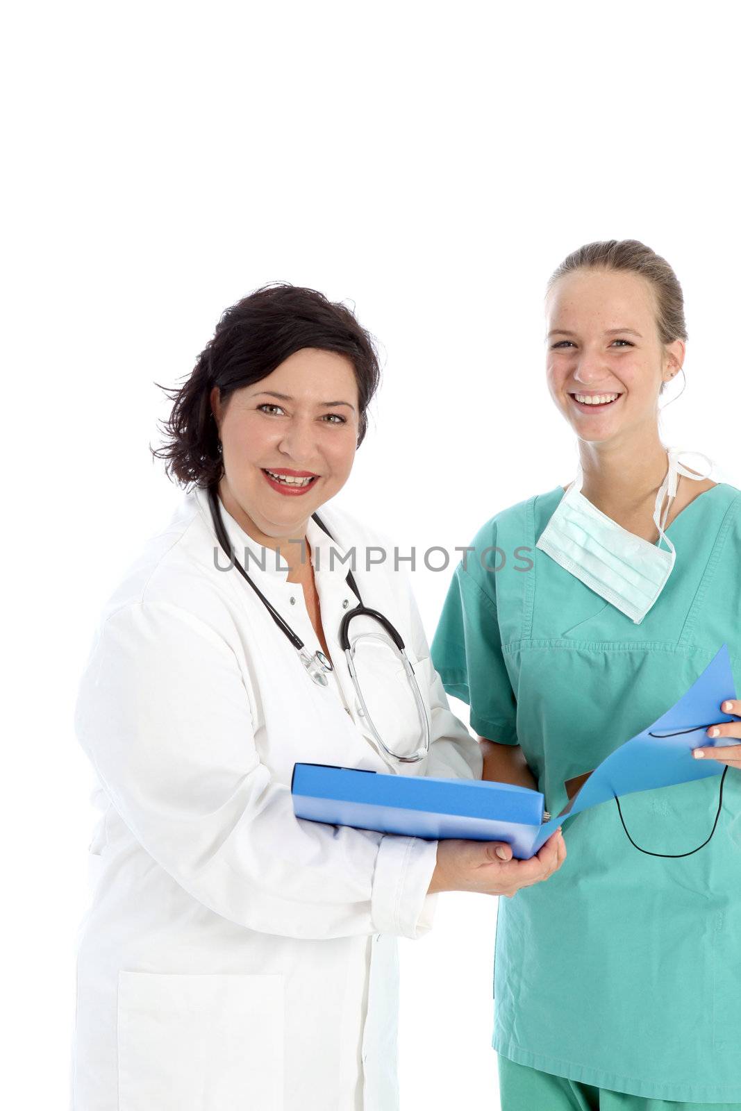 Smiling positive female doctor and nurse standing with a blue folder discussing the successful treatment of a patient 