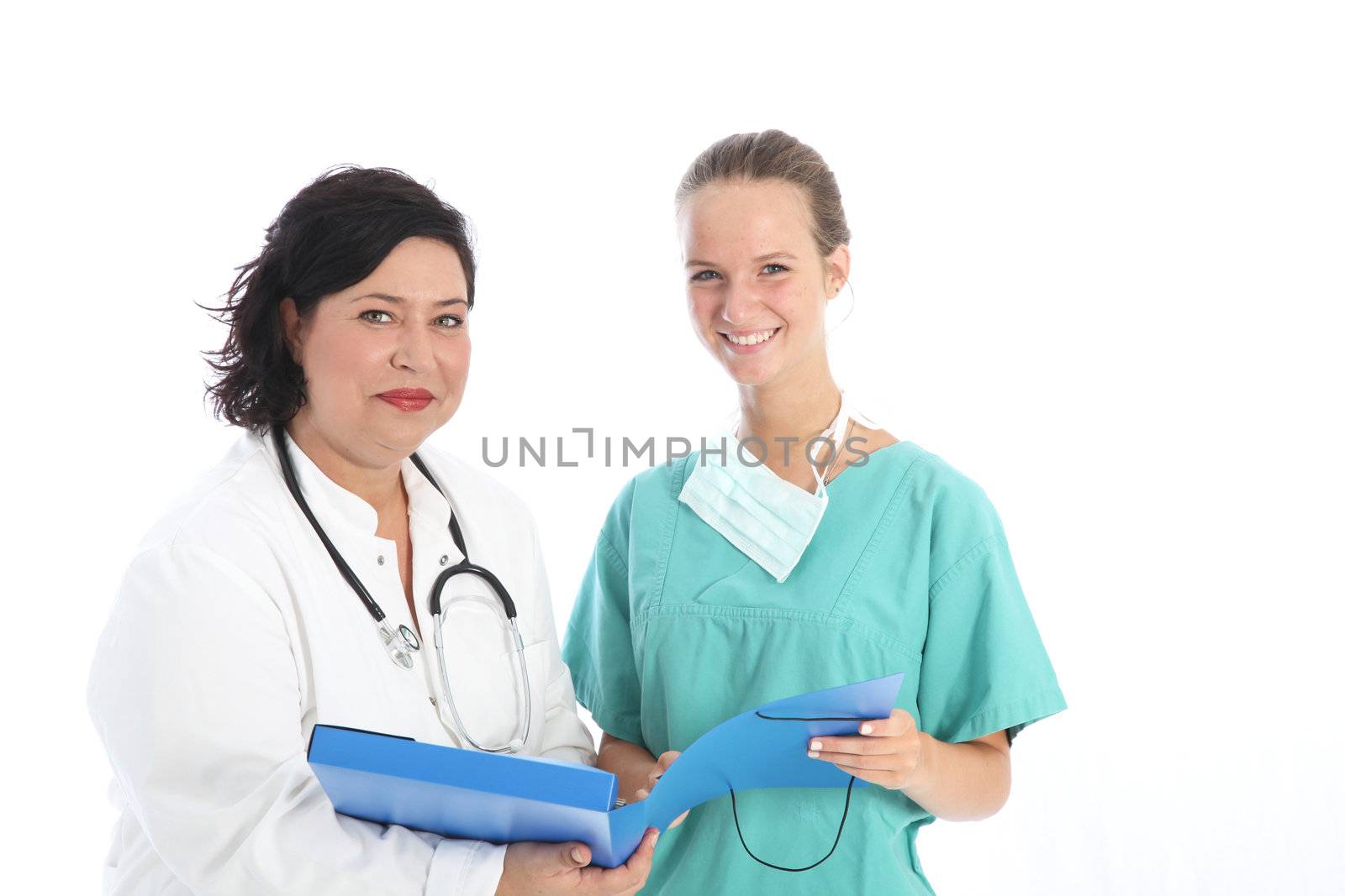 Happy female doctor and nurse standing together discussing the days rounds in the hospital isolated on white 
